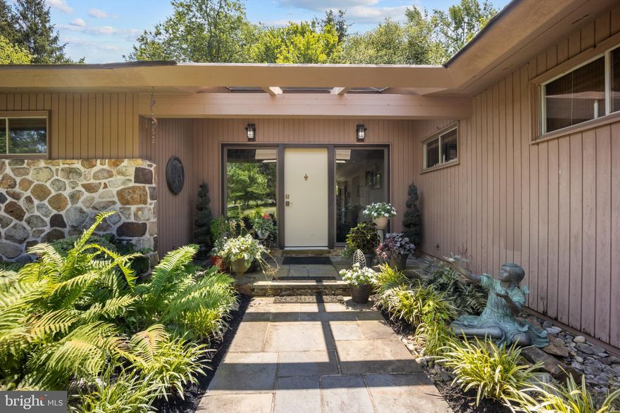 Step into timeless design and smart sustainability with this stunning 4-bedroom, 2.5-bath home, thoughtfully crafted with inspiration from Frank Lloyd Wright. Nestled on a serene, one-acre lot, this property offers a harmonious blend of organic architecture and modern comfort.  Expansive passive solar windows flood the home with natural light while maximizing energy efficiency—keeping you comfortable year-round. At the heart of the home, a striking centralized stone fireplace serves not only as a bold design feature but also as a natural heat source, radiating warmth to the surrounding living spaces.

From clean lines to open-concept flow, every detail embraces balance and nature. The spacious layout includes a primary suite retreat, generously sized bedrooms, and versatile living areas perfect for entertaining or peaceful relaxation.  Ranch style design welcomes you to a stunning foyer where you step down in a sunken living room with floor to ceiling windows overlooking the grounds, coupled with a dining room fit for entertaining.  The Outdoors offer sweeping views, privacy, and room to grow, garden, or simply unwind. A true one-of-a-kind property for the design-savvy buyer who appreciates timeless architecture and smart living.  Several rooms including the primary have decks and slate patios out sliding doors where you can step outside to enjoy the outdoors a hot tub and gazebo.  Circular Driveway leads to a spacious 2 car garage.  Do miss this incredible home nestled in a development.  This home is not part of the neighboring HOA.