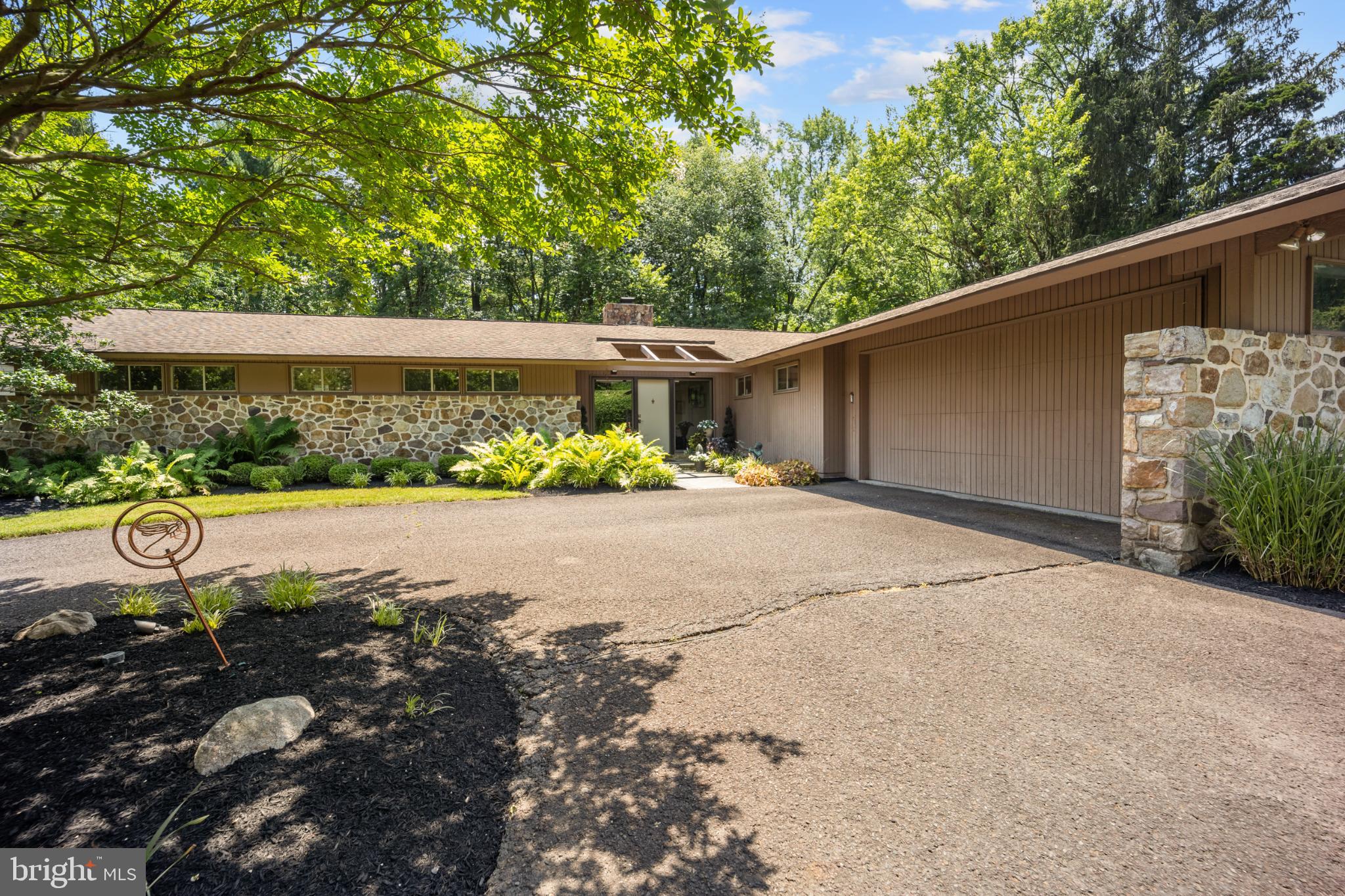 Step into timeless design and smart sustainability with this stunning 4-bedroom, 2.5-bath home, thoughtfully crafted with inspiration from Frank Lloyd Wright. Nestled on a serene, one-acre lot, this property offers a harmonious blend of organic architecture and modern comfort. Expansive passive solar windows flood the home with natural light while maximizing energy efficiency—keeping you comfortable year-round. At the heart of the home, a striking centralized stone fireplace serves not only as a bold design feature but also as a natural heat source, radiating warmth to the surrounding living spaces.
From clean lines to open-concept flow, every detail embraces balance and nature. The spacious layout includes a primary suite retreat, generously sized bedrooms, and versatile living areas perfect for entertaining or peaceful relaxation. Ranch style design welcomes you to a stunning foyer where you step down in a sunken living room with floor to ceiling windows overlooking the grounds, coupled with a dining room fit for entertaining. The Outdoors offer sweeping views, privacy, and room to grow, garden, or simply unwind. A true one-of-a-kind property for the design-savvy buyer who appreciates timeless architecture and smart living. Several rooms including the primary have decks and slate patios out sliding doors where you can step outside to enjoy the outdoors a hot tub and gazebo. Circular Driveway leads to a spacious 2 car garage. Do miss this incredible home nestled in a development. This home is not part of the neighboring HOA.