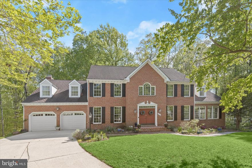 Exceptional brick colonial nestled in the prestigious and private King’s Contrivance enclave of Columbia, offering refined living on beautifully landscaped grounds.  Set on .63 acres, the property boasts manicured landscaping and a fenced backyard that opens to permanent open space with the potential for a pool, creating a private and picturesque outdoor setting. A striking French door entry introduces a dramatic two-story foyer adorned with a Palladian window, crown molding, chair railing, and elegant box wainscoting, setting the tone for the home’s timeless sophistication.  Gracious formal living and dining rooms are designed for elevated entertaining, each enhanced by rich hardwood flooring, detailed millwork, and refined accents. The dining room’s bay window and wall sconces create a warm, ambient setting. At the same time, an adjoining flex/game area offers versatility and seamless access to the screened-in deck, perfect for effortless indoor-outdoor gatherings.  The gourmet kitchen is thoughtfully appointed with a center island, peninsula breakfast bar, abundant cabinetry, and sleek appliances, flowing into a sunlit breakfast room and an inviting family room. Here, a brick-surrounded wood-burning fireplace, custom trim, and deck access provide a comfortable yet elegant retreat overlooking serene natural surroundings. A private office with custom built-ins and a well-placed powder room complete the main level.  Upstairs, the luxurious primary suite serves as a true sanctuary, featuring hardwood floors, a spacious sitting room, dual walk-in closets, and a spa-inspired bath with double vanity, jetted soaking tub beneath a skylight, and a separate walk-in shower. Four additional generously sized bedrooms and two full baths offer ample accommodations.  The fully finished lower level presents exceptional flexibility with a private entrance, full second kitchen, living and dining areas, bonus space, and a bedroom suite, ideal for multigenerational living, guests, or upscale entertaining. Conveniently located near major commuter routes, including I-70, US-29, and MD-32, with easy access to premier shopping at The Mall in Columbia, world-class performances at Merriweather Post Pavilion, and community amenities within the Huntington/Dickinson neighborhood.