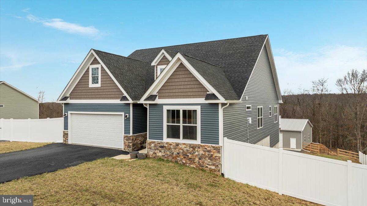 Spring is Here and The Grass is Green! Look What You Get in YOUR NEW Home: Beautiful views, Stunning home, and the cherry on top is the 48 x 36 HUGE with electric, detached garage with 3 bays for all of your toys! (BE SURE TO WATCH THE VIDEO!) Only 3 years old, this home offers so much with 5 (Yes, 5!) bedrooms, large open living areas, maintenance free deck with gorgeous views, stamped patio space, and so much more! The gourmet kitchen features granite counter tops, and a large island that will be perfect for entertaining in your wide open living area complete with gas fireplace and vaulted ceilings. The primary bedroom will be a welcome retreat with tray ceiling, 2 walk in closets, and a relaxing soaking tub. Downstairs you will have even more living space with a large bonus/office area , full bathroom, rec room with easy walk out to your back yard. Do not wait to experience this home in person! Call your agent or the listing agent today!