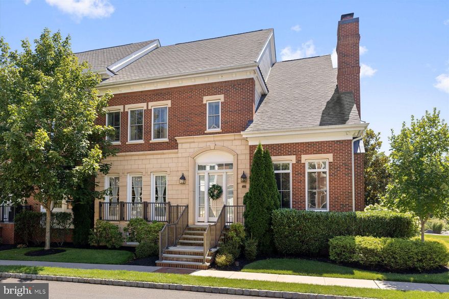 Welcome to Rabbit Run Creek, an exclusive gated community of just 37 homes set on 20 acres of landscaped gardens and woodlands. This premier end-unit residence, offering more than 5,500 square feet across three levels, was originally the model home and showcases the community’s most sought-after upgrades. The chef’s kitchen is the heart of the home, featuring Wolf and Sub-Zero appliances, Asko dishwasher, pot filler, reverse osmosis water system, garbage disposal, expansive marble island, and custom cabinetry. A large butler’s pantry connects seamlessly to the formal dining room, creating an ideal setup for both everyday use and larger gatherings. From here, the layout flows to the large stone-walled patio—an entertainer’s dream—with outdoor fireplace, grill, sink, refrigerator, fountain, ambient lighting, outdoor TV, and speakers. Guests can move easily indoors and out, while the lower level’s exterior access offers a natural extension for family and friends. The living areas include a formal dining room and living/music room with fireplace, as well as a spacious open living area for casual gatherings. Upstairs, the luxurious primary suite features a fireplace, sitting area, multiple chandeliers, a custom dressing room, and a spa-like bath with soaking tub and dual vanities. Two additional bedrooms with en-suite baths, laundry and bonus rooms, plus an office nook complete this level. All three levels are connected by elevator.
The finished lower level expands the home’s entertaining and lifestyle options with a glass-enclosed wine room, a granite-topped bar with TV, refrigerators, microwave, and dishwasher, a large game and lounge area with 10-foot projector TV, and a gym with half bath. This level also enjoys its own entrance, offering flexibility for guests or a potential in-law suite. Additional highlights include three interior gas fireplaces, a seven-zone Sonos sound system, Lutron lighting, high-end alarm and video surveillance systems, whole-house water purification and softening, and abundant storage throughout. The location is as appealing as the home itself—just a mile from downtown New Hope’s shops, dining, and culture, and within easy reach of Princeton, Philadelphia, and New York City.