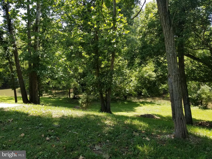 Opequon Creek frontage, .74 acres, private access to creek, high on the hill out of flood plane but easy to lower area. Partially wooded for shade. This lot has existing well, private septic for 3 bedrooms, NO HOA, no property restrictions. Two campers on lot, one older with no title, second one has title and is 2004 Montana Mountaineer Keystone model, 34 feet, hitch to back bumper. Moved once to existing location.  Water and septic hookup already in place. Everything is in working order. New awing to cover wooden deck, furniture and kitchen equipped.  Sleep extra if you have guests. Queen bed was upgraded for sleeping comfort. Additional camper is being removed by the seller. Newer storage shed/barn for storing your kayak or canoes, lawnmower, etc. Live in the camper and build your waterfront dream home.