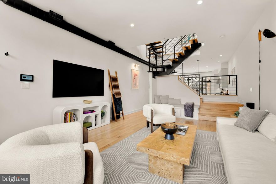 Discover an extraordinary retreat in the bustling Shaw neighborhood at 2114 10th St NW. This meticulously designed three-level residence offers a unique blend of modern luxury and timeless charm. As you step inside, you're greeted by an abundance of natural light streaming through thoughtfully positioned windows, creating an inviting and serene atmosphere.

The open floor plan showcases premium hardwood floors and dramatic high ceilings, seamlessly connecting the living spaces. The central staircase acts as a striking focal point, encouraging exploration from the cozy living room to the elegant dining area, and inviting culinary creativity in the state-of-the-art kitchen. Equipped with top-of-the-line appliances, including a Subzero fridge and Dual Wolf ovens, the kitchen is complemented by a hidden pantry and sleek Dornbracht fixtures.

Ascending to the second floor, you'll find two generously sized, sunlit bedrooms accompanied by a sophisticated guest bath. The third floor is dedicated entirely to the luxurious primary suite, offering a tranquil escape. This sanctuary features a spacious bedroom, a custom-designed bathroom, and an expansive walk-in closet, all illuminated by a stunning designer chandelier.

Step outside to the private backyard oasis, perfect for outdoor entertaining. The space boasts elegant stonework and warm wood accents, with an Al Fresco dining and living area surrounding a cozy gas fire pit. Secure & discreet rear parking enhances convenience of the property.

High-end amenities such as heated bathroom floors, a steam shower, and automatic blinds provide an elevated living experience. Situated just steps from Whole Foods, 930 Club, shopping, dining, and public transportation, this home offers an unparalleled combination of luxury and accessibility, earning a Walk Score of 99. Experience the exceptional lifestyle this rare gem has to offer.