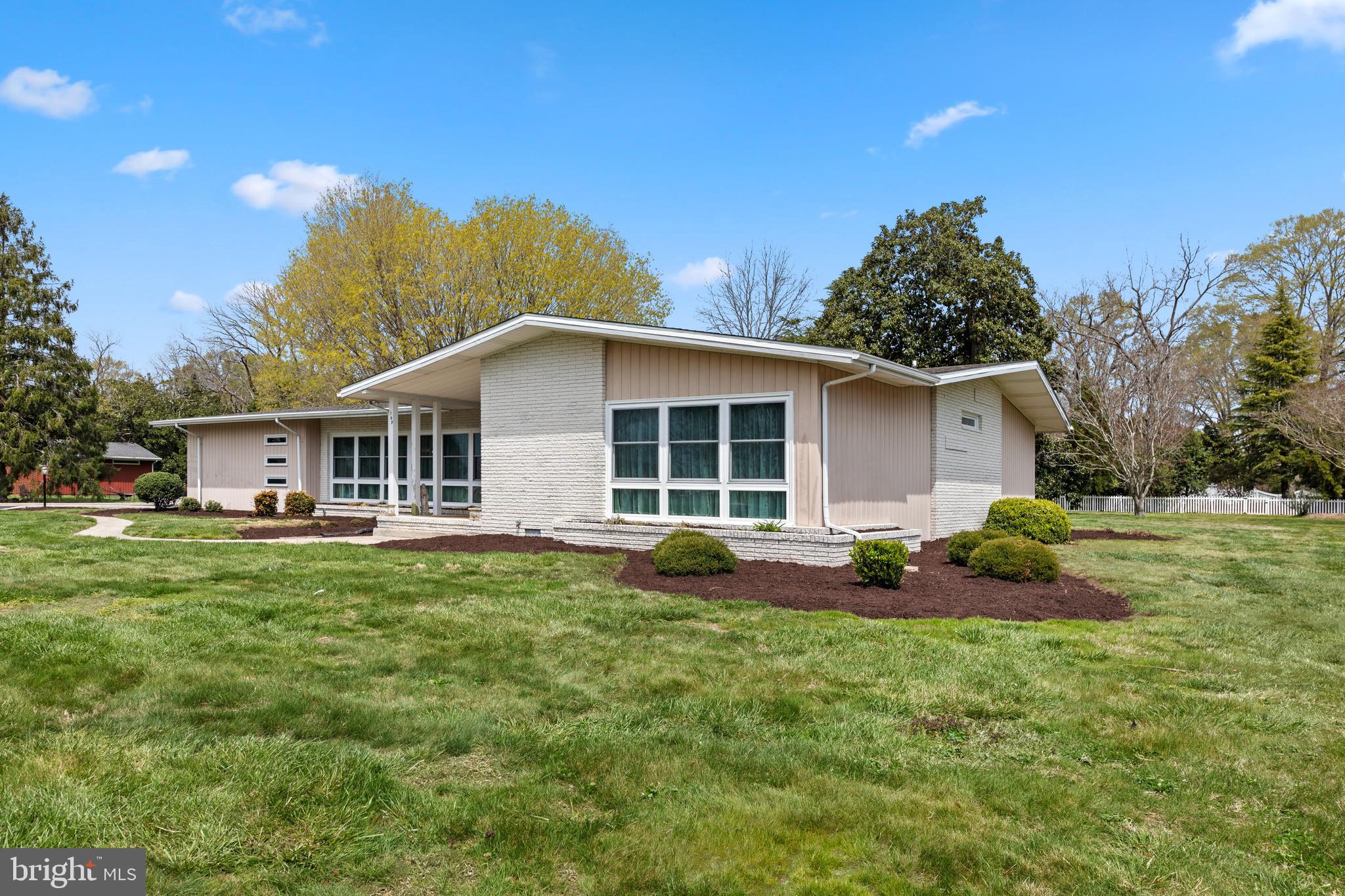 Mid-Century Modern Gem in the Heart of Berlin!
Discover the perfect blend of character, space, and location in this beautifully updated one-story Mid-Century Modern home, ideally situated on 1.16 acres in the Town of Berlin—just a short stroll from your favorite coffee shops, ice cream parlor, boutiques, restaurants, toy stores, and more.
Step inside through the statement-making double open doors into a bright and airy entryway that flows effortlessly into a sun-filled open living and dining space. The home has all new, double tilt-in floor-to-ceiling windows that fill the home with natural light while offering modern efficiency and easy maintenance. The electric fireplace adds ambiance and charm—and can easily be converted to a wood-burning setup if desired.
The kitchen features brand-new appliances and eco-friendly Marmoleum flooring made from sustainable, non-toxic materials, and opens into a flexible space perfect for a home office, additional dining, or a cozy reading nook.
One of the showstoppers of this home is the oversized primary suite—complete with a dedicated vanity area, a walk-in closet with built-in dressers and a private full bath designed for both comfort and convenience.
Additional highlights include a second spacious bedroom with its own full bath, updated flooring throughout, a new roof, and an encapsulated crawl space for added efficiency and peace of mind & a 3-car garage. Outside you'll find a partially fenced in yard shaded by mature trees, providing both privacy and a serene space to relax, entertain, or garden.
This rare in-town property delivers modern updates and Mid-Century charm—all within walking distance of downtown Berlin’s vibrant local scene.
**Don’t miss your opportunity to own a one-of-a-kind home in one of Maryland’s most charming towns. Schedule your private showing today!**