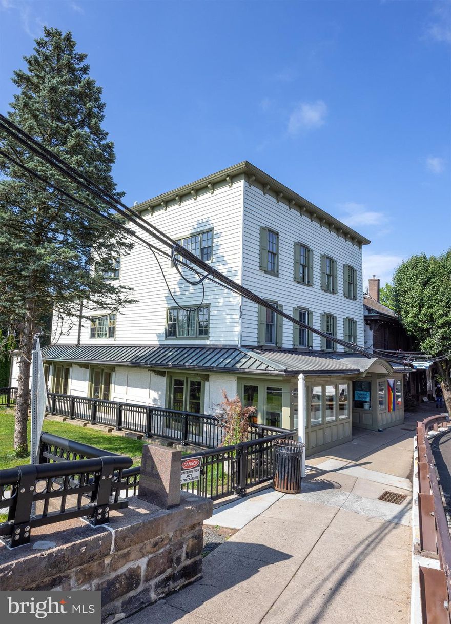 Perched at the grand entrance to New Hope from the iconic bridge from Lambertville, NJ, this fully leased, 6 unit investment property underwent a full scale renovation circa 2006 and features two street level retail stores and four apartments.  With an excellent history of tenancy, this prime location has always drawn reliable commercial shops benefiting from some of the highest foot and vehicle exposure available in town.  Located across the street from Starbucks and Dunkin' Donuts, approvals were previously granted for an expansion of 750 SF of the main level commercial space.  Adjacent open-space (with sculpture) is owned by the DRJTBC and is fenced off from the public, providing plenty of buffer for the premium apartment views of the river.