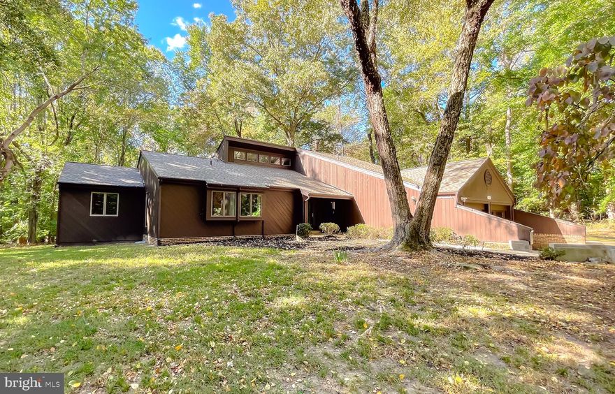 Very nice contemporary on 6.55 acres in Port Tobacco.  New architectural shingles on entire roof.  New gutter guards.  Entire exterior of home painted with 2 coats exterior grade paint.  4 new entry doors and 4 new security storm doors installed.  New insulated garage door and motor.  Upgraded insulation through-out the house, walls and ceiling.  New drywall, paint and trim in the garage.  Garage floor painted and flaked.  Garage cabinets added.  Half bath remodeled.  Kitchen remodeled to include new cabinets, granite countertops, ceramic tile backsplash, appliances and lighting.   There is also an attic pull down stairs in the Kitchen that has another room with flooring.   LVP flooring through-out kitchen, dining room, foyer and hallway.  New interior paint, walls and ceiling through-out.  Luxury primary bathroom with dual oversized shower and bidet, whirlpool tub.  Skylight in hallway.  Full hall bath with ceramic flooring, ceramic walls and ceramic ceiling.  Basement stairwell remodeled, basement floors and walls primed and painted.  All new smoke detectors and carbon monoxide detectors installed through-out the home.  5 exterior ring cameras installed.  Driveway resurfaced to the property line.  Home has boiler with in floor heat in living room, dining room, den, kitchen, laundry room and powder room.  Zoned boiler heat throughout bedrooms and bathrooms.  New exterior AC condensor.  Detached garage/building in rear of home.  If privacy is what you are looking for this is the place and only minutes to La Plata.