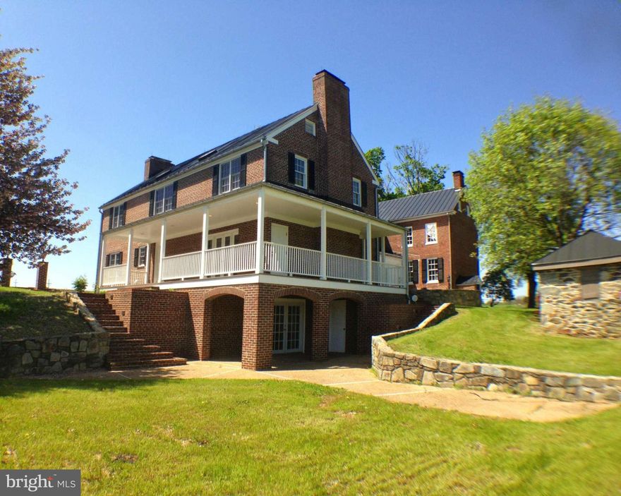 First class renovations have restored this 6 BR 4.5 bath all brick home to all it's grandeur. Sited on a 3 acre lot w/ mountain views & ever flow creek.  Classic floor plan w/original refinished hardwoods, windows, door knobs, locks and hardware, chandeliers and 9 wood burning brick fireplaces. Restored crib barn w/loft serves as 2 car garage. Seller will consider owner financing.