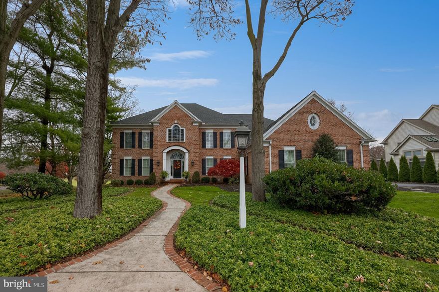 Perfectly situated within the prestigious, gated community of Bent Creek, this stately brick two-story home at 78 Oakhill offers breathtaking, unobstructed views of the 1st fairway and green. With over 5,367 square feet of sophisticated living space, this sprawling residence blends luxury with premier country club convenience.  From the moment you enter, the home’s character is defined by exceptional custom millwork, intricate molding, and detailed built-ins that carry throughout the home.  The home's elegant flow is ideal for both grand entertaining and private comfort. It features a sunken living room with a gas fireplace and custom built-ins, a formal dining room with a tray ceiling, and two separate first-floor executive offices. At its heart, a chef's kitchen opens to a massive deck, providing a seamless indoor-outdoor experience with stunning golf course vistas and sunsets.  Upstairs, the luxuriously appointed primary suite is a true retreat, complete with a large primary bedroom, adjacent changing room, a massive walk-in closet, and a spa-like bathroom featuring a dual vanity, jetted tub, and a huge tiled walk-in shower. Storage is abundant throughout, from the spacious wardrobes, a cedar closet, and a large unfinished basement, ensuring every belonging has its place.  Four additional bedrooms and ample bathrooms provide space for everyone too.  Designed for modern convenience, the home includes efficient natural gas heat, central A/C, three fireplaces, and a three-car garage. Located in Manheim Township School District, this is a rare opportunity to own an exceptional property in one of Lancaster's most coveted addresses.