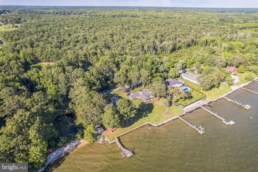 Welcome to your waterfront retreat on the Potomac River! This well-maintained 3-bedroom, 2.5-bath rambler is perfectly situated on a level 1-acre lot with stunning panoramic water views from every rear-facing room, including all bedrooms. The spacious kitchen opens to a cozy family room with a wood-burning fireplace, ideal for relaxing or entertaining. Step out to the screened-in porch or deck—complete with a hot tub that conveys—and soak in the peaceful riverside setting.

Energy efficiency meets comfort with a geothermal heating and cooling system and paid-off solar panels, keeping utility costs low year-round. The impressive 8-foot wide pier is in excellent condition and features a boat lift and jet ski lift, ready for crabbing, fishing, kayaking, or boating adventures. A recently replaced $100,000 sea wall adds lasting value and protection to the shoreline. A large workshop with electric near the pier offers great space for projects or extra storage. With a 2-car garage and unbeatable views, this riverfront gem has it all!