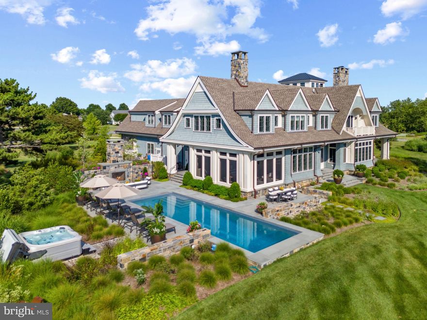 Nestled within the prestigious and secluded confines of the waterfront community of Cove Creek Club, this striking New England-inspired waterfront estate rests on the banks of Tanners Creek with a private pier and easy access to Eastern Bay. Ideally situated on 1.76 acres with 319 feet of water frontage, this ultra-luxe 7,100+ square-foot, 4 bedrooms, 5.5 bathrooms, custom Nantucket Shingle-style home was recently built in 2021 with premium quality finishes, all furnishings and décor convey with the home creating a truly turn-key property (with some exceptions).  With breathtaking views, exquisite design, waterfront saltwater pool, hot tub, amenities-rich community and top-tier finishes, 101 Cove Creek Court is truly one-of-a-kind and showcases unparalleled craftsmanship. No expense was spared with this stunning home  Hammond Wilson (Architects), Erin Paige Pitts Interiors, Focus Construction and the landscape architect, Campion Hruby worked seamlessly together to create a trophy home and property in a league of its own. The property both inside and out is an entertainer's dream from the multiple waterside patios, enclosed screened porch, theater room, and gourmet Kitchen with built-in pizza oven to the custom wine tasting room and cellar which boasts domed ceilings and Venetian plaster walls with walk-in temperature and humidity-controlled wine room that stores well over 1,000 bottles. The four spacious bedrooms including the upscale bunk room with two queen beds and four twin beds with an ensuite bath are sure to accommodate guests, family and friends comfortably and the elevator makes everything accessible. The Primary suite is thoughtfully designed with soaring ceilings, gorgeous fireplace surrounded by built-ins, private balcony, custom walk-in closet, luxurious bath with double sinks, spa-like shower and soaking tub with breathtaking water views. The home office/library with fireplace, gym, laundry room and theater complete the second floor and provide plenty of space and activities for the whole family. Head up the spiral staircase to enjoy 360-degree views from the bird's nest or step out on the balcony for an endless panoramic view of Poplar Island, Eastern Bay and beyond. Cove Creek Club community offers exclusive features such as a private beach, marina, tennis/pickleball courts, golf course, and scenic walking trails, providing an unparalleled lifestyle of leisure and recreation. Easy commute to the Bay Bridge and nearby amenities which includes Starbucks, Target, grocery stores and restaurants. This impeccable home promises endless opportunities for relaxation, fun, and cherished memories by the water's edge. Welcome Home!