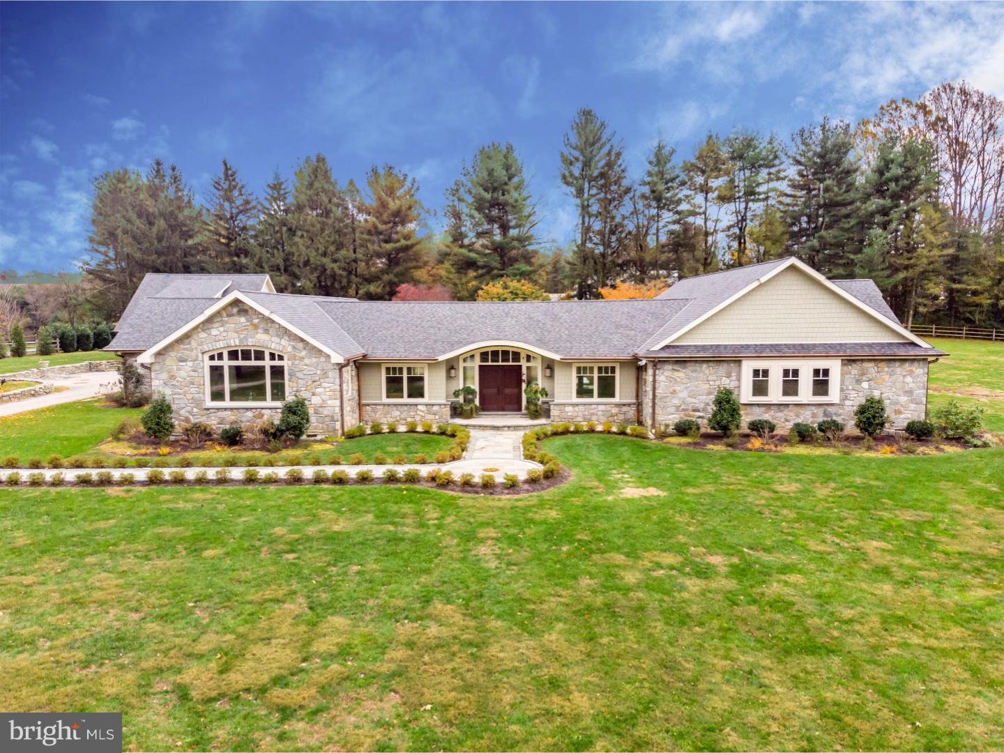 Absolutely breathtaking 4 bedroom, 3.2 bathroom ranch home on a picturesque 4.2 acre lot in desirable Radnor Hunt and Great Valley schools. This completely renovated home offers an open concept and has sweeping views from every window. After driving through the gated entry, you are welcomed into an expansive great room that is currently used as a dining and living room. The show stopper kitchen is like no other- vaulted, decorative ceiling; custom inset cabinetry; commercial grade appliances; and granite counters. Off of the kitchen is a family room with built-in bar and cabinetry and direct access to the outside. The mudroom with built-in cubbies and closet systems is perfect to store coats, sports equipment or towels for the incredible pool. The newly finished fitness studio with walls of mirrors and mat flooring is the perfect space for Yoga, Pilates or overall relaxation. The master suite offers an incredible tiled bathroom with dual vanity, soaking tub and fabulous shower; 2 closets with built-in shelving systems and a walk-in closet with island dresser and vanity area. Three other bedrooms- all with customs closets by California Closets- one with ensuite bathroom and the other two that share an updated hall bathroom. The laundry room offers more cabinetry for added storage. The inside is completed with two updated powder rooms- one formal and one informal off of mudroom. The exterior in absolutely incredible with stone patio that overlooks pool with cedar decking and new stone coping. New stone patio and steps to be installed behind the pool while a outdoor kitchen and prep area complete this outdoor oasis. The two car detached garage with Belgium block entry was recently renovated and has an additional laundry area to service the second level one-bedroom apartment with updated kitchen and newly remodeled bathroom. All of this while being close to all major roadways for an easy commute to Philadelphia and NYC; minutes to Malvern Borough and downtown Wayne and central to some of the best private schools in the country- Epis Academy, Malvern Prep, and Phelps School. This property truly has it all and is like no other; make your appointment today, it will not last long! *rear yard to be completed in the next few weeks*