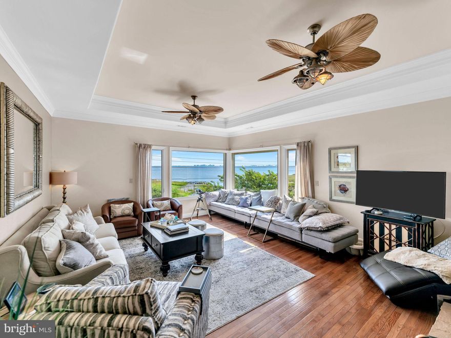 Welcome to the Best of West Ocean City – Where Coastal Elegance Meets Waterfront Luxury

This exceptional south-facing waterfront residence offers panoramic, unobstructed views of the Ocean City skyline, blending refined coastal design with high-end amenities for a truly one-of-a-kind lifestyle. With 60± feet of bulkhead, a brand-new seawall, and a private boat lift just steps from your outdoor living area, this is a water lover’s paradise designed for effortless enjoyment and entertaining.

Step into resort-style living with a fully screened, Florida-style heated pool oasis featuring a tranquil waterfall, outdoor bar/kitchenette, beverage fridge, ice maker, sink and microwave, and bar seating. Whether you’re hosting sunset cocktails or al fresco dinners under the stars, this outdoor retreat brings relaxation and sophistication together beautifully.

Inside, the home offers a thoughtfully designed layout with multiple living zones. The first floor includes a poolside family room with its own washer and dryer, a private guest suite, and two additional serene sleeping retreats—ideal as guest bedrooms, reading nooks, home office, home gym or flex spaces for extended family.

Upstairs, the open-concept living area features a dramatic great room, chef’s kitchen with gas cooktop and premium appliances, and a spacious dining area—perfectly designed for entertaining. The luxurious primary suite is a private sanctuary, offering a electric fireplace, whirlpool spa bath, walk-in closet, and a private balcony overlooking the peaceful canal. Two additional bedrooms, plus the iconic “Whiskey Room” with its cozy fireplace and sweeping bay views, complete the second level.

Additional highlights include an elevator, oversized garage, city sewer, private well with water softener, and recent upgrades including a new roof, updated HVAC system, and an owned propane tank.

From luxury finishes to resort-style outdoor living, this extraordinary property delivers the ultimate in coastal living. Don’t miss your chance to own a true slice of paradise in one of Ocean City’s most coveted waterfront communities.