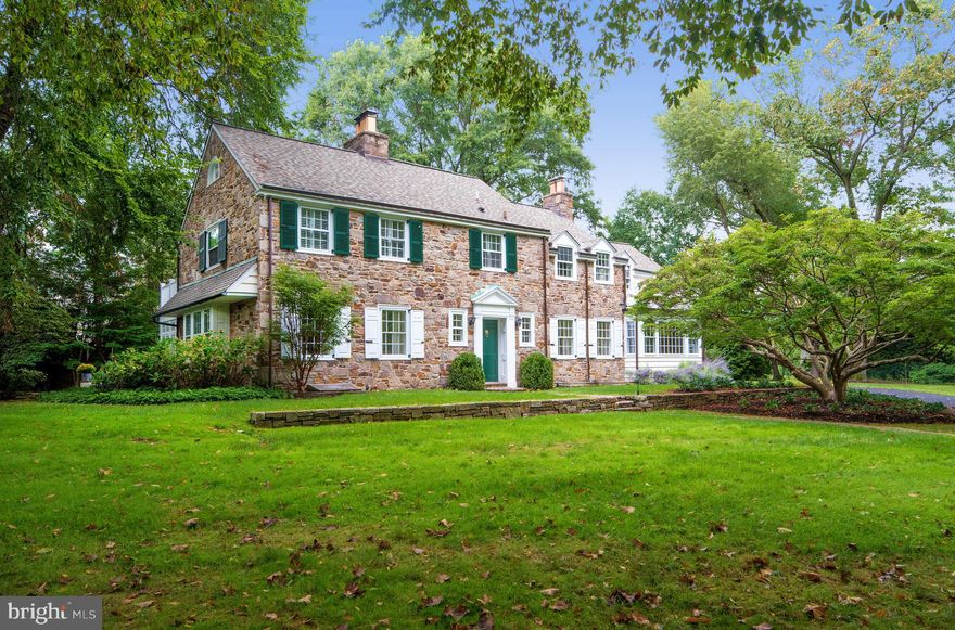 Enjoy the best kind of living in this traditional 5 bedroom, 4.5 bath Main Line Pennsylvania stone estate. This beautiful home offers a private setting, and an ideal environment to raise a family! Situated on a large lot graced by mature plantings, the expansive, elegant residence sits far back on the property behind lush shrubbery and tall trees, with no homes to the east affording a sense of quiet and serenity. The gracious interior, introduced by a large entry foyer with a lovely main staircase, is brightened by generous windows and brimming with distinctive architectural details. Tasteful moldings & millwork, arched openings, rich hardwoods, and 4 charming fireplaces are among the classic, timeless features. From small intimate spots for family time, to the grand rooms that are perfect for parties and special occasions, the flow is excellent inside and out. Enjoying the outdoors is easy, whether to relax or entertain, with a wonderful covered porch and spacious paver stone patio for dining al fresco providing a blissful setting. In any weather, the gorgeous window-enveloped sunroom brings the outdoors in. A living room with fireplace and separate dining room are comfortable gathering places for family and guests. These formal rooms are complemented by a fabulous renovated kitchen, the heart of the home, and a chef s dream. Wood floors & cabinetry, granite countertops, a center island with a cooktop, storage & seating, stainless steel appliances, an integrated wood-paneled refrigerator, built-in workstation & sun-bathed breakfast area create an inviting, functional space. Before or after dinner, lounge and watch TV in the family room with a fireplace, built-ins, and window wall overlooking the scenic grounds. The main level laundry/mudroom offers capacious storage, and a family entrance. Retreat to tranquil, well-proportioned bedrooms when the day is done. The master is particularly peaceful, with a huge luxurious en-suite spa bath. All baths have been impeccably remodeled, as has the sunroom, lower level, and garage. The finished basement extends the living space with a 2nd family/media room with fireplace, and an updated full bath. A newer roof and HVAC top the appeal of this exceptional offering. You ll also love the location, on the coveted North Side of Bryn Mawr, with convenient access to shopping, dining, Center City, the airport and more!