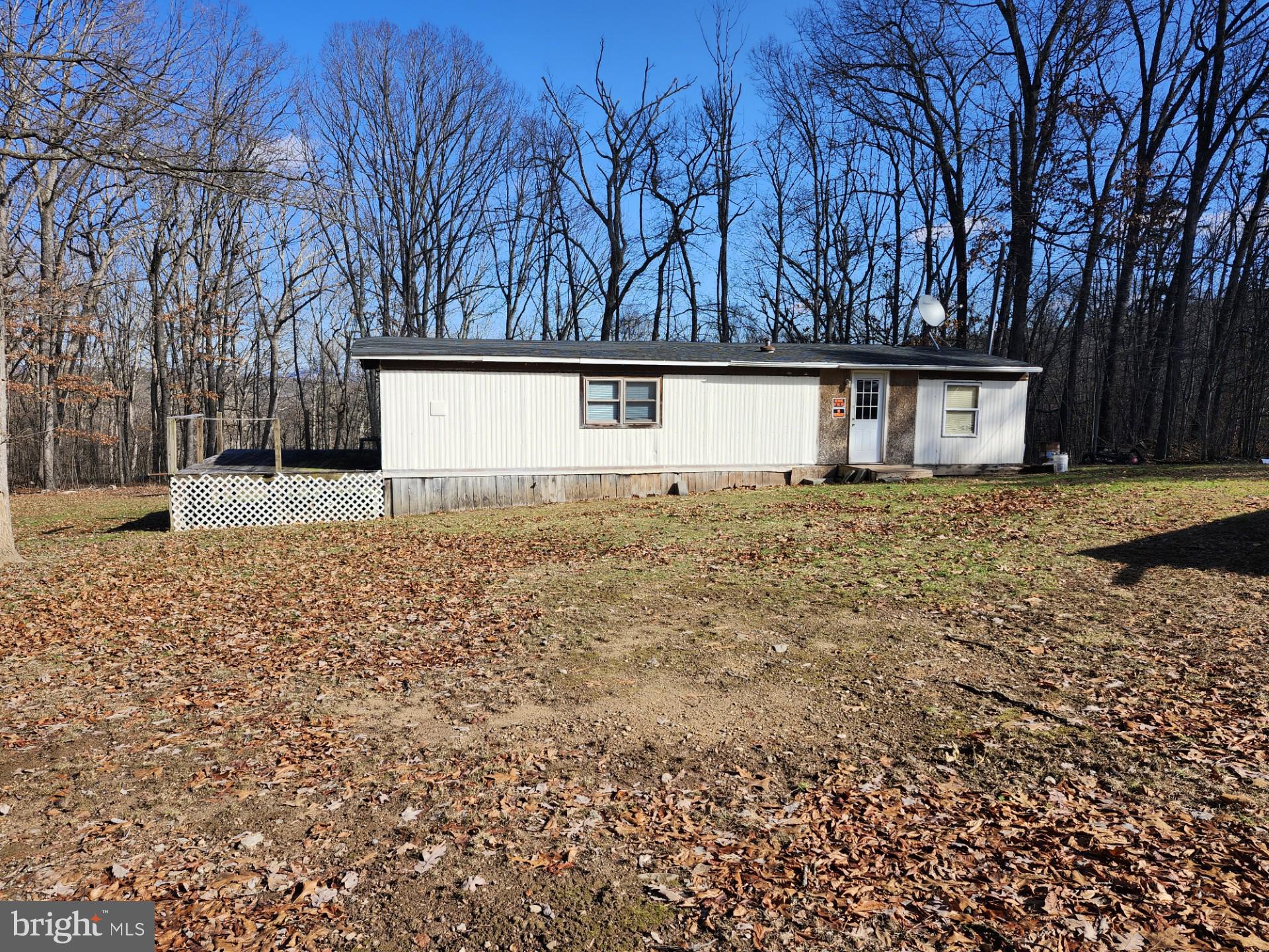 LOOKING FOR A PLACE TO GET AWAY, WITHOUT BREAKING THE BANK, THIS 3.71 ACRES IS IMPROVED BY A SINGLE-WIDE MOBILE HOME, 300 FOOT WELL, THERE IS A 500 GALLON WASTE DISPOSAL TANK BURIED THAT WOULD NEED PUMPED EVERY COUPLE MONTHS, LOT IS EXTREMELY LEVEL, IT HAS A BEAUTIFUL YARD, AND BACKS UP TO A LARGE SECTION OF WOODS WHICH PROVIDES ALOT OF PRIVACY AND EXCELLENT HUNTING AS YOU CAN SEE IN THE PICTURES!!!!! CONVENTIONAL SEPTIC COULD BE EASILY INSTALLED, THIS PROPERTY HAS ALOT TO OFFER, TONS OF WILDLIFE, DEER, TURKEY, BEAR ETC..............MOBILE HOME IS 2 BEDROOM, 1 BATH, AND INCLUDES PELLET STOVE, WASHER/DRYER, FRIDGE & COOKSTOVE.