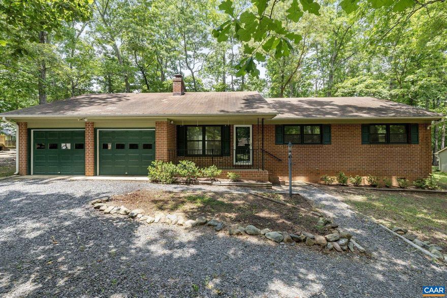 They don't build them like this anymore. Come See this One Level,  Brick Home  with an oversized 2 car garage.   Spacious Living Room with a brick, wood burning fireplace with insert, Large eat in Kitchen with wood cabinets, refrigerator, dishwasher & electric range, breakfast bar.   Adjacent laundry room has a utility sink, washer/dryer.   Primary bedroom with an attached 1/2 bath, 2 additional bedrooms & full bath.  Very level lot with a concrete front porch & wood back deck, circular driveway.  HVAC replaced in 2021.  The oversized garage has plenty of room for your own workshop and storage area.  With a little TLC you can make this home your own.  Located in beautiful Lake Monticello just east of Charlottesville, VA.   VACATION YEAR ROUND! Amenities include: 352 Acre Fishing/Swimming/Boating Lake, tennis & pickleball courts, basketball courts, playgrounds, athletic fields, fishing pond, 18 Hole Championship Golf Course, 2 Clubhouses, 5 beaches & 5 exit/entrance gates.  Restaurants, shopping & medical facilities located outside the gates.,Formica Counter,Wood Cabinets,Fireplace in Living Room