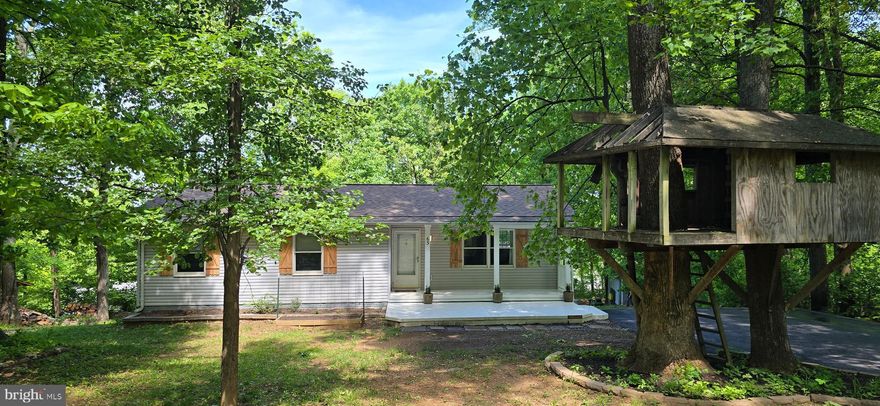 MOTIVATED SELLERS! WINTER VIEWS! MOVE IN READY! FRESH PAINT & NEW FLOORING! LEVEL 1 ACRE MOUNTAIN LOT! PRIVATE! Beautiful home on Blue Mountain that glows through the trees when the sun shines! You are going to LOVE it!  INTERIOR: Living room opens into the dining area & upgraded kitchen with stainless steel appliances, updated lighting, butcher block counter, and more. Convenient door off breakfast nook to upper level deck (12X10). Primary bedroom has been turned into a suite with attached office/dressing room with his & hers closets. Lower level has huge family room with wood burning stove w/gorgeous stone mantel, Full bath, laundry, 3rd bedroom, and workshop! OUTDOOR FEATURES: Super cool treehouse for those young at heart to enjoy! Covered front porch (19x10.) Level yard with playground, garden area, lower level deck (16x16), shed, wood shed, and perfect spot for a fun private pool one day! RECENT UPDATES: Hot Water Heater 2025, Whole House Filter 2025, Upgrade Air Return 2024, Refrigerator 2024, Roof 2024 (TruDefinition® Duration® AR, full ice shield, upgraded venting, with transferable warranty), Dishwasher Pump 2023, AC/Heat Pump 2018.  STORAGE: Attic storage accessed through bedroom 2 with stairs (11 x 22,) Storage shed (10 x 14,) Wood shed (11.5 x 5.5.) NOTE:  Home is located in the Blue Mountain Property Owners Association.  NO HOA. There are NO dues to be paid directly to BMPOA.  However, in addition to Real Estate taxes, there is a separate Blue Mountain Sanitary District (BMSD) tax. Warren County collects both of these taxes in two equal installments on June 5th and December 5th of each year. Like the real estate tax, the BMSD tax varies depending on the county valuation or assessment of the property.  See view docs for covenants and bylaws.  COMMUNITY: There is a community lodge and a lake to be enjoyed by residents. This subdivision is a Sanitary District in Warren County.  See Blue Mountain Property Owners Association website for more details.