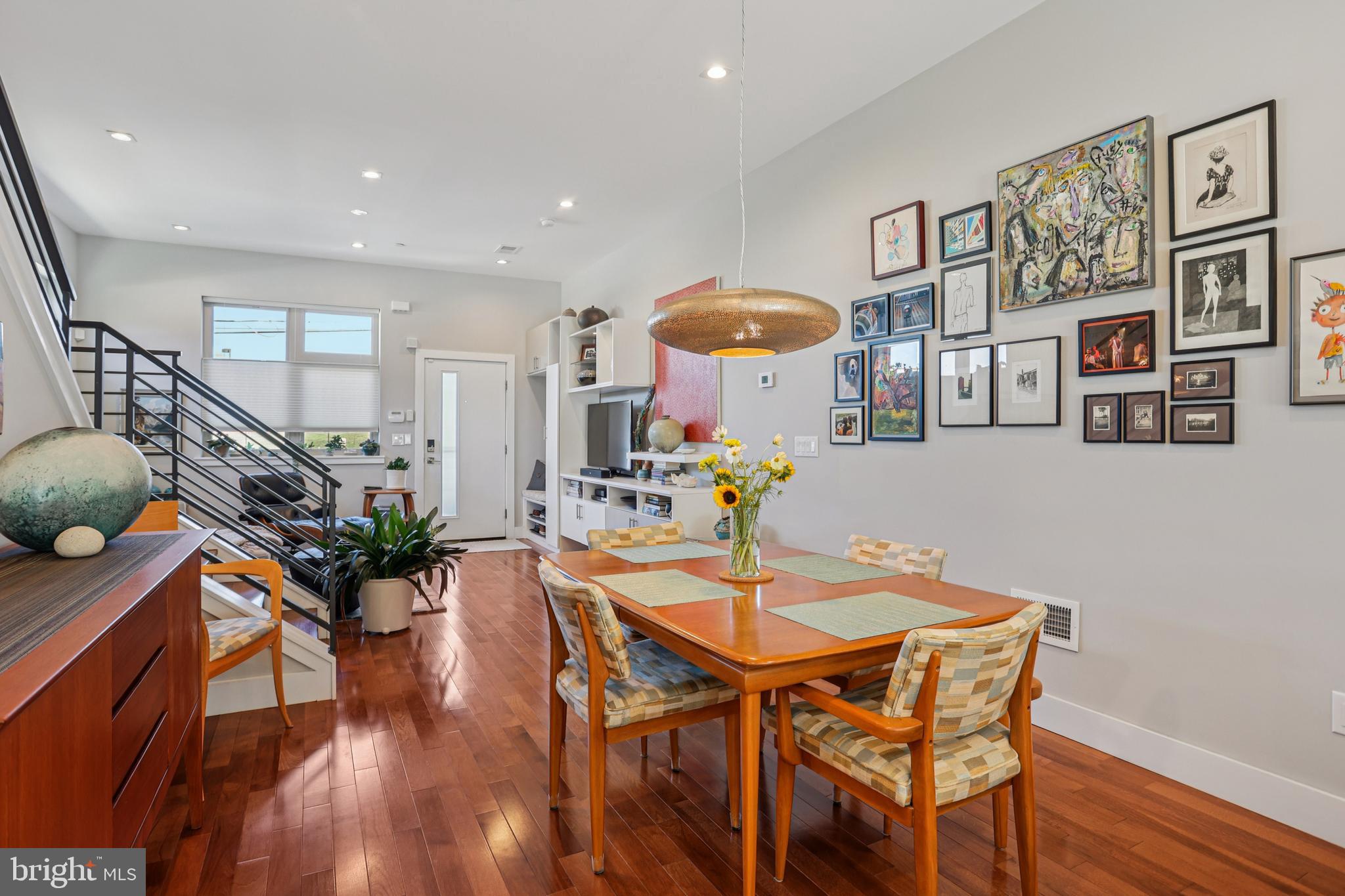 Welcome to 2567 E Thompson Street, a modern, well designed, twin home completed in 2018, with approximately three years remaining on the tax abatement. This home features a coveted dedicated PARKING spot right outside your back door. Step inside to a bright and airy living space featuring solid hickory hardwood flooring, 9' and 10’ ceilings, oversized windows – complete with custom fitted shades, and recessed lighting throughout. The living area is outfitted with a custom California Closet built-in storage and entertainment center, and extra side windows for additional natural light. The open layout flows seamlessly into the dining area with easy seating for 6-8. The kitchen is at the rear of the home, where you’ll find white shaker cabinetry, dark gray quartz countertops, a Whirlpool stainless steel appliance package, including a gas range, room for 4 countertop seats, and a walk-in pantry with custom shelving from Closetworks. A convenient powder room and sliding glass doors to the rear complete the main level. The finished basement offers even more living space, with its own powder room and egress. Two bedrooms with double closets and a full bathroom are located on the 2nd level. The laundry room with an Electrolux washer & dryer and the added 2nd zone HVAC unit, is also on this level, along with TWO additional linen/storage closets. Upstairs, the spacious primary suite easily fits a king-sized bed and includes a generous walk-in closet with more custom shelving. The ensuite bathroom is a spa-like retreat with a floating dual-sink vanity, soaking tub, and glass-enclosed shower with triple shower heads. For added convenience, there is another powder room and large closet on this floor to accommodate guests when entertaining on the roof. The full, private roof deck with stunning views of the Center City skyline and unobstructed 360° views completes this exceptional home. This convenient location puts you close to all the shops, cafés, and restaurants that make Fishtown one of Philadelphia’s most vibrant neighborhoods. Local walkable favorites include Il Ghiottone, Picnic, Bastia, Riverwards Produce Market, Czerw’s Polish Kielbasa, Starbucks, your friendly local IGA, and so much more. And with easy access to I-95, 676, Delaware Ave, and the Market-Frankford Line, this home has it all!