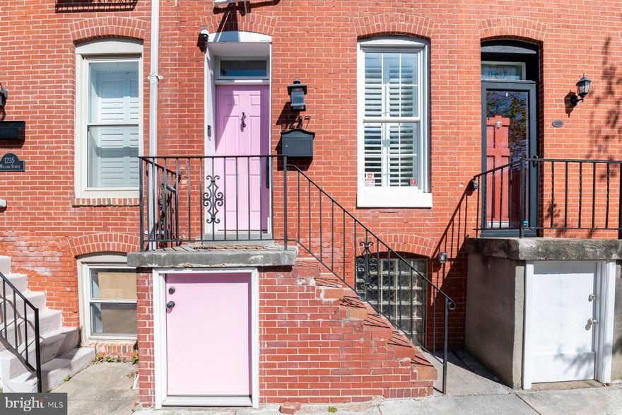The famous Federal Hill pink door house is finally available, and it checks every box on your city living wishlist: a coveted location, a true TWO car parking pad, and a rooftop deck with gorgeous Baltimore views.
Inside, you’ll find over 2,100 finished square feet across four levels, packed with style and smart updates. The main level blends charm and polish with exposed brick, wood floors, and crown molding. The on-trend kitchen features custom shaker cabinetry, quartzite countertops, a farmhouse sink, top of the line appliances, and a dedicated dining space perfect for entertaining.
Whether you have regular guests or roommates, this floor plan is incredibly functional - each of the three bedrooms has a private en suite bath. The lower level adds a versatile bonus room and powder room, ideal for guests, workouts, or work-from-home flexibility.
Tucked on a quiet block just steps from everything Federal Hill has to offer, this is the whole package!