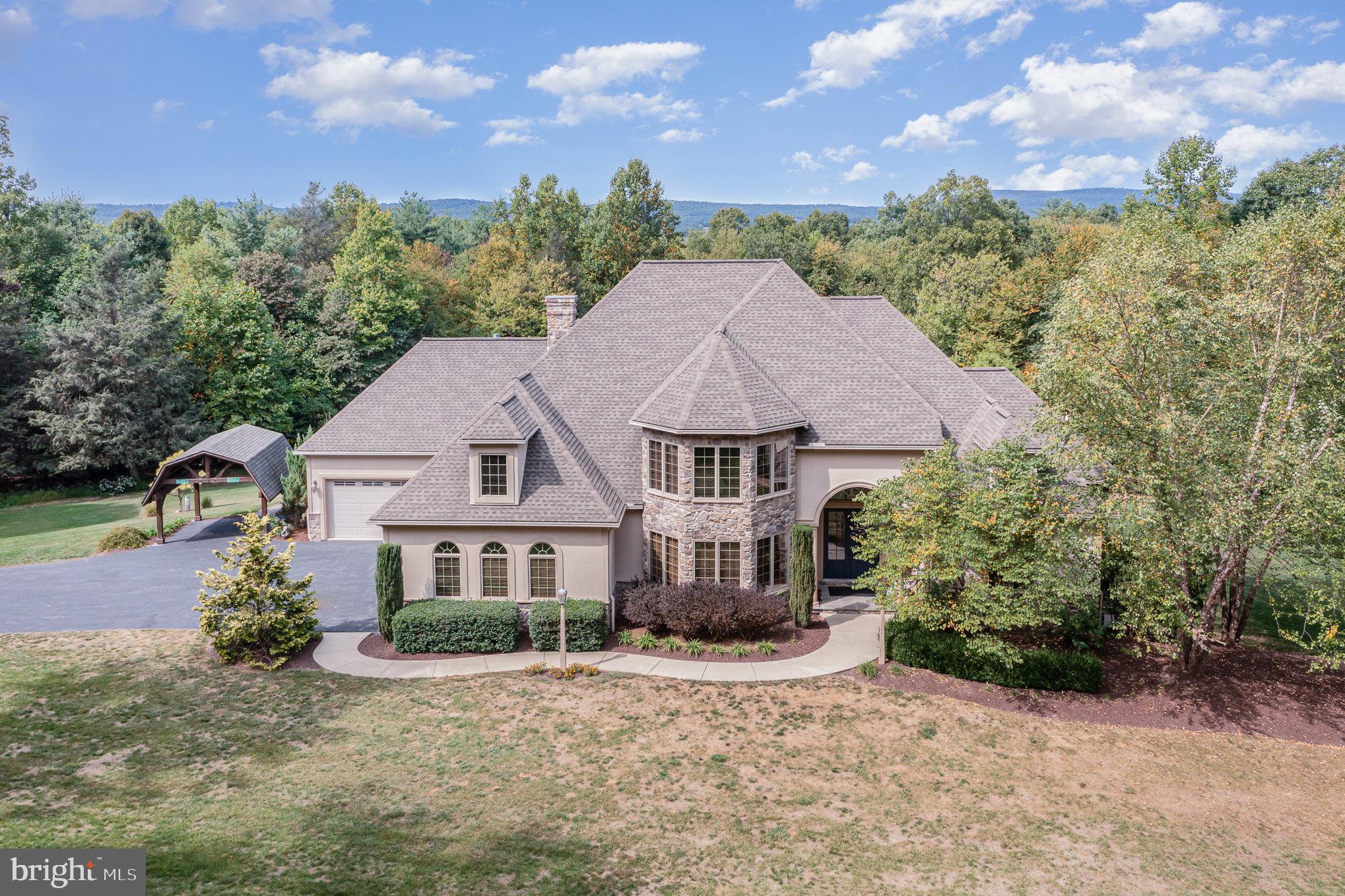 Welcome to your dream retreat nestled in a serene rural setting! This stunning traditional-style home, built in 2010, offers a perfect blend of modern comfort and timeless elegance. With 4 spacious bedrooms and 4.5
bathrooms, this residence is designed for both relaxation and entertaining. As you approach the property, you'll be captivated by the charming exterior, featuring a combination of durable Dryvit and stone materials that enhance its curb appeal. The expansive 45.32-acre lot provides ample space for outdoor activities and showcases breathtaking views of lush trees and scenic vistas, creating a tranquil backdrop for your everyday life. Step inside to discover a warm and inviting atmosphere, highlighted by a cozy fireplace that serves as the heart of the home. The well-appointed kitchen and open living spaces are perfect for gatherings, while the attached oversized garage with space for up to five vehicles ensures convenience and ample storage. The primary bedroom boasts of a second fireplace and the perfect balance of luxury and functionality. Outside, indulge in your own personal oasis with your private spa and pool, ideal for summer relaxation and entertaining guests. The property also features outbuildings, offering additional storage or potential for creative use. This exceptional home is not just a residence; it's a lifestyle. Embrace the peace and privacy of rural living while still being within reach of local amenities. Don’t miss the opportunity to own this remarkable property that perfectly balances comfort, style, and nature. Schedule your private tour today and experience the beauty and tranquility for yourself!