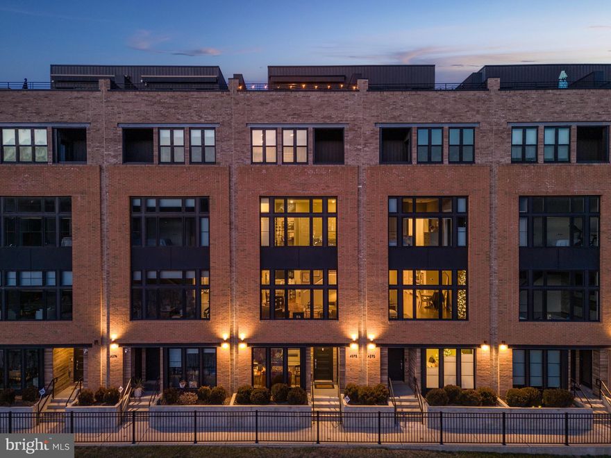 Welcome to serene riverfront living at "The Locks" townhome community in historic Manayunk. This luxurious, extra-wide townhome boasts prime positioning in the community and features extensive upgrades throughout. As you enter this EnergyStar certified home, you'll find a spacious flexible room with custom built-in bookshelves, currently used as a home office but perfect as a den or recreation room.

Take the 5-stop elevator or stairs to the next level and enjoy the bright, open floor plan with high ceilings and built-in speakers connected to an upgraded audio system with components, receiver, and amplifier. The upgraded eat-in chef's kitchen features Bosch & Thermador appliances, subway tile backsplash, pendant lighting, a large island with seating for four, ample custom-built storage, a pantry, and custom cabinetry. Adjacent to the kitchen, a conveniently situated powder room awaits your guests. The living room offers a wall of extra-large windows for natural light and extraordinary river views, perfect for relaxation.

The third floor houses two spacious bedrooms, including an en-suite with spectacular river views, a dedicated laundry room with upgraded full-sized washer and dryer, custom-built cabinets, and a modern hall bathroom. The fourth floor is a luxurious private owner's suite and sanctuary, featuring a terrace for serene moments, a versatile den/study currently serving as an elegant office space/dressing room with a bespoke built-in closet system. This space can easily be converted into a nursery or full office. Additionally, the hallway has expanded built-in custom closets for ample storage. The primary bathroom features a double vanity, a custom stall shower, and a soaking tub.

The rooftop terrace is a private oasis, perfect for entertaining, with stunning river and neighborhood views. Additional features include dual zone HVAC with wifi-controlled thermostats, electric remote-controlled Bali roller shades on all levels with blackout features in all bedrooms, solar window tinting for energy efficiency and privacy, finished composite decking on the river side, a fully motorized, remote-controlled retractable awning, and a weather-resistant exterior ethernet connection for outdoor media and entertainment.

With 5 years remaining on the tax abatement, this home, currently configured as a 3-bedroom with flexible spaces for a 4th, offers an exceptional opportunity. Don't miss out!