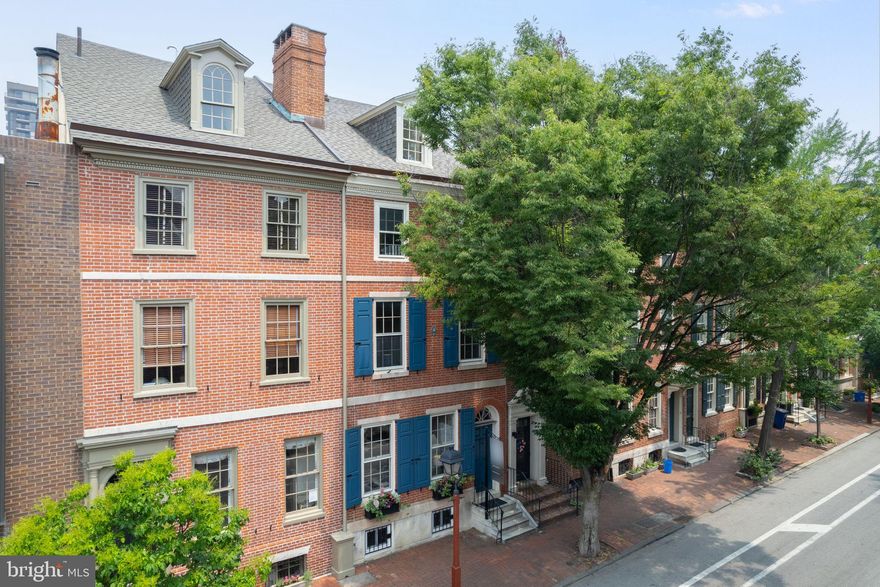Magnificent spacious and historic, light-filled townhome on a tree-lined Society Hill block. This c.1808 home was one of the original homes listed on the Philadelphia Register of Historic Places and has 5 bedrooms plus a capacious family room, 3.5 baths, and a finished lower level. It offers stunning, quintessential early 19th century Federal character throughout, yet includes renovations and updates to superb 21st century standards. From the 10' ceilings to the original random-width pine floors throughout. The huge 12-pane double hung south-facing windows to the original moldings. The original wood-burning fireplace to the light filled dining room and updated eat-in kitchen. The just renovated luxurious primary suite to the huge family room plus the finished lower level. Built-ins. Nooks and crannies. Original detail. Fully rewired electric. Skylight and huge windows for spectacular light throughout. Cozy, private patio. Well-maintained mechanicals. Superb space and layout. A+ location. 99 WalkScore. Parks, super-markets, restaurants, coffee shops, farmers’ market… just everything. Plus Seller Paid Garage PARKING less than two blocks away.