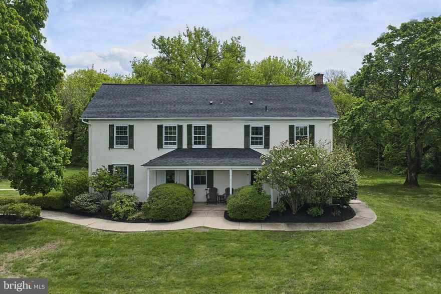 Venerable meets whimsical in this charming stone farmhouse, filled with original features and lovingly preserved by its owners. A plastered front and exposed stone sides pleases both the purist and 21st century aficionados. Wide plank pumpkin pine floors, chair rails, crown molding, and deep windowsills grace the formal rooms in the house, while exposed beams and interior exposed stone walls call to the lovers of rustic living. The kitchen, with its brick floor and stone walls, shares an open space with a big walk-in fireplace (and propane stove) that still harbors a beehive oven. Three staircases and three attics attest to the different eras that built this house, blending all into a cohesive retreat. Bathrooms are updated, with a Carrera marble walk-in shower and a clawfoot tub. The barn is a happy surprise, offering a cozy office space or studio, complete with running water, heat and air conditioning, a sound system and WiFi. It even has a Prohibition-era bar! Big barn doors swing open to provide beautiful long-distance views. Next to the office, a former blacksmith shop still retains its original forge. A huge covered 3-bay carport serves as a garage. Placed back from the road and surrounded by farmland (don't miss the horses next door), this property hosts a little fenced garden reminiscent of Colonial days and a small orchard. The public sewer has recently been installed, retiring the septic system, and a whole house generator comes with the property. You need do nothing but move in!