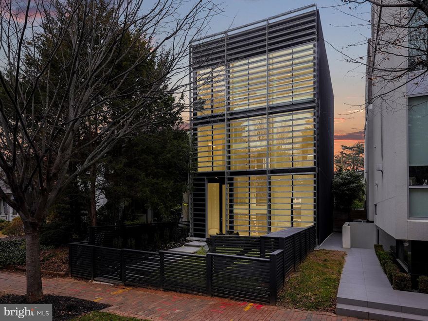 Welcome to La Casa Di Vetro! Step into a home where the harmony of light, glass, and minimalist living creates an atmosphere of futuristic sophistication.

This extraordinary modern residence is hidden behind an artistically designed steel and glass exterior, nestled in the heart of Burleith. A masterpiece by Maple Development, it embodies the core principles of modernist design, a testament to the visionary approach of Travis Price Architects.

Every inch of this home is imbued with custom finishes, striking a harmonious balance between minimalistic elegance and opulent grandeur. The sleek chef's kitchen serves as the epicenter of the main level, boasting bespoke cabinetry, state-of-the-art Miele stainless steel appliances, and full height custom glass walls. The ingenious use of glass creates an unparalleled infusion of natural light, seamlessly blending the indoors with the outdoors. 

The Acadia Glass System and privacy fins ensure an abundance of daylight while preserving seclusion. The open layout, ideal for dining and entertainment, allows for a seamless flow between the kitchen, the entire main level, and the expansive private slate patio.

Floating staircases, crafted from steel and adorned by white oak floating treads, lead the way to the exceptional primary suite—an oasis of serenity surrounded by organic design elements. A custom walk-in closet and a sumptuous en suite bath, complete with a bespoke vanity, a luxurious soaking tub, and an ethereal glass waterfall shower, epitomize the opulence of the primary suite. The den/office offer versatile living spaces to adapt to a variety of needs.

The remaining bedroom suites emulate the graceful sophistication of the primary suite. 

Situated in the heart of downtown living, this move-in ready home places the very best of dining, shopping, errands, and entertainment at your doorstep. Within minutes, you can explore Wisconsin Avenue, Embassy Row, or venture to the Waterfront, ensuring an endless array of experiences. 

Nature escapes and scenic trails are within reach, with Dumbarton Oaks Gardens and Glover Archbold Park nearby. This home, a true masterpiece, surpasses every item on your wishlist and redefines modern luxury living.