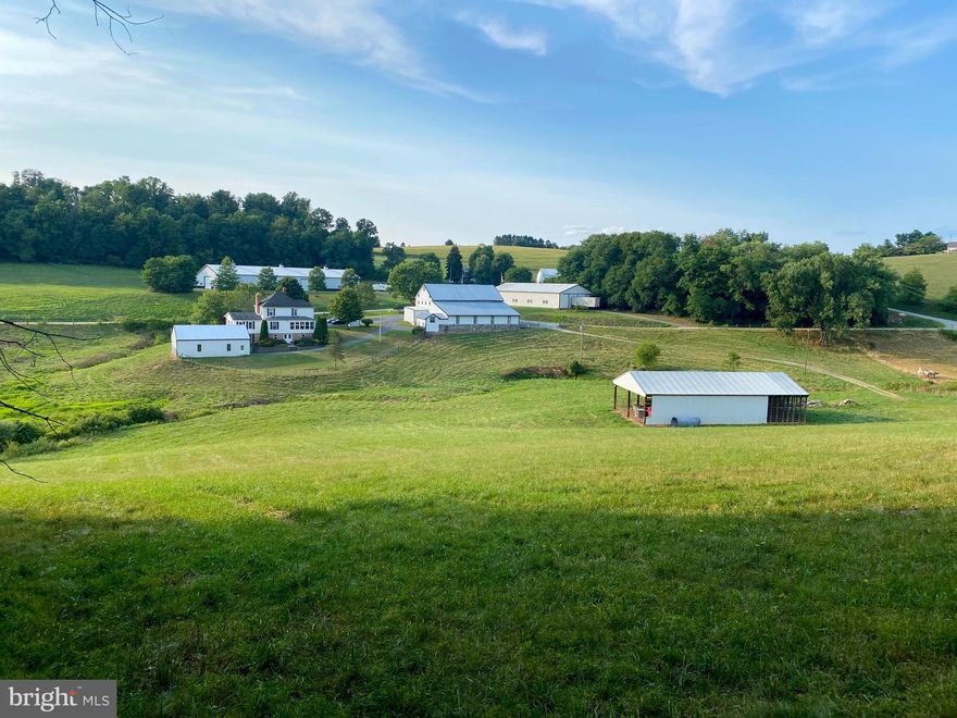 Tucked away in Southern York County just minutes from the MD/PA state line sits a rare opportunity to own this impressive 75+/- Acre Farm. This 2 story 5 bedroom 2 bath farmhouse was originally built in the 1920s and later remodeled with an addition that was completed in 2007. As you enter the home from the large relaxing porch the updated country kitchen welcomes you home featuring custom cabinets made of Wormy Chestnut along with original builtins. The kitchen is filled with bright sunshine from the windows overlooking the pasture. Enjoy the option of a first-floor bedroom suite with a luxury bath. Soak in the jetted tub or enjoy the walk-in shower. Continuing through the home to the second floor you will find 4 additional bedrooms. Original hardwood floors along with Chestnut doors and trim can be found beautifully restored throughout the home. The 75.60 acres are made up of 2 parcels (53.71 acres with farmhouse/outbuildings & 21.89-acres of raw land).   This amazing property includes multiple outbuildings allowing for endless storage space for your farm equipment, car collection, boat, RV, trailers, or hobbies. One of the main features of the property is the custom-built 180x80 insulated Morton Pole Building offering over 14,000 sq ft of storage. This building was previously used as a private museum to display antique automobiles and equipment complete with a waste oil heating system as seen in the photographs. Additional pole buildings on the farm feature concrete floors, electricity, insulation, and heat. The Bank Barn is well kept with newer metal siding and electricity. 
Spend the day enjoying your favorite hobby in one of the many outbuildings. Enjoy the beautiful sunsets while relaxing on the front porch of the home or building. This property offers endless possibilities with everything this farm has to offer, the choice is yours. Call today for more information or to make arrangements to schedule a showing of this property.