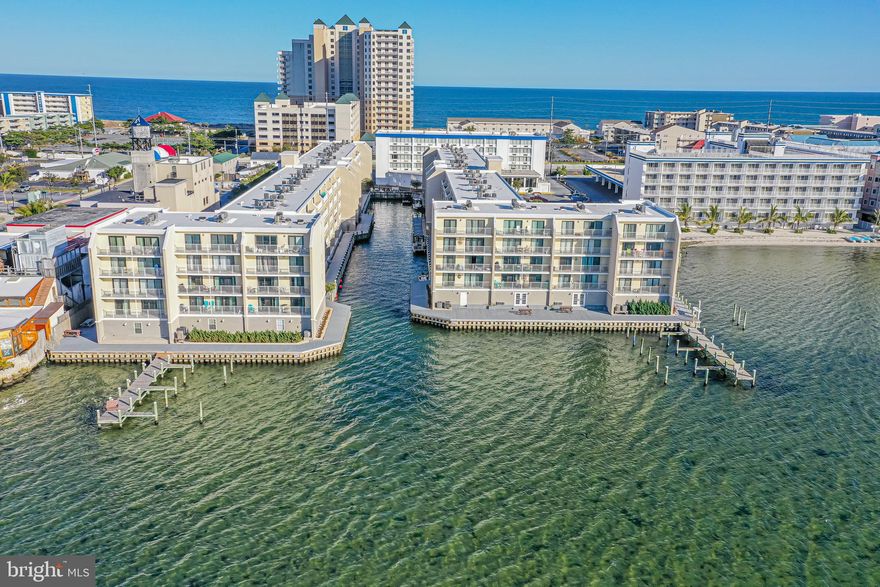 BEAUTIFUL BAYSIDE WATERFRONT LIVING!!! This 2BR, 2BA  Penthouse-Level Unit has been delightfully designed and decorated! This unit boasts an oversized balcony with access from the living room and the primary bedroom. New HVAC, New Luxury Vinyl Plank Flooring Throughout, New Base Trim Throughout. WiFi Doorknob, WiFi Thermostat.  Newer Building Roof, New Bulkhead and Walkway. Condo Association has been great about maintenance! Completely turnkey with tasteful furnishings. All furniture, TV's, Wall Décor, Kitchen Items Convey and Balcony furniture conveys. Bedroom furnishings include a Queen-size bed and a King-size bed. Living room has a Queen-size sleep sofa. Located in the heart of Midtown. Close to the Beach!! All Beach Items Convey. Close to restaurants, shopping and activities! Boat and Jet Ski slips are available to rent on a first come first serve basis. Storage available for rent, also on a first come first serve basis. On-site laundry. Bayfront outdoor pool. Reserve study has been completed and there has been a $5,000.00 special assessment as a result. This assessment has already been paid in full by the Seller.  Great rental income!