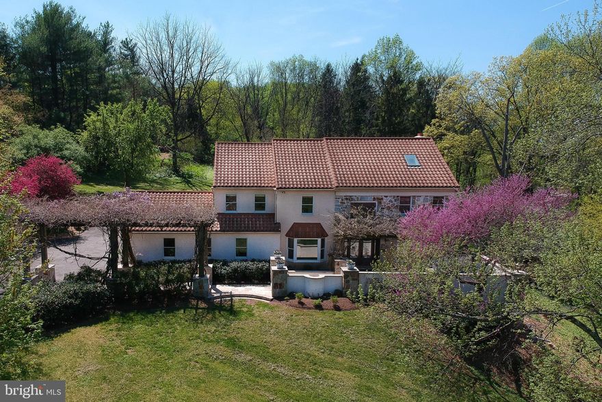 Enjoy the best of reﬁned living in this Italian villa-inspired home, privately nestled on a
sprawling 1.81-acre lot in Conshohocken. This 4-bedroom, 3.5-bath residence seamlessly
blends classic elegance with modern amenities, creating an exceptional setting for both
relaxation and entertaining. The gourmet kitchen features two spacious islands for prep
and entertaining, dual sinks for efficiency, and custom cabinetry with deep drawers to
keep everything organized. The primary suite offers a private retreat with rich hardwood
ﬂoors, a dedicated office nook, a spa-inspired bath and walk-in shower with imported
Italian Carrara Marble tile. Three additional bedrooms, including a unique two-story loft
bedroom with a dramatic skylight and beamed ceiling, provide ﬂexible options for
guests, work, or creativity. Step outside to the front terrace, where a Tuscan-inspired,
wisteria-draped pergola frames elegant travertine tiles underfoot - all set beneath the
distinctive charm and durability of an updated metal terra cotta style roof. Enjoy the
fragrant blooms and dappled shade as you take in panoramic views and breathtaking
sunsets - perfect for relaxing with a glass of wine or entertaining friends as the evening
sky transforms with color. In the backyard, multiple patios, lush landscaping, a sparkling
pool, and a relaxing hot tub create an entertainer’s paradise - ideal for alfresco dining or
quiet mornings surrounded by nature. The home also features a fully ﬁnished walkout
basement with a full bath - perfect for use as an in-law suite, guest quarters, or ﬂexible
living space. Wine enthusiasts will appreciate the dedicated, climate-controlled wine
storage room-perfect for preserving and showcasing your collection. Families will
appreciate the award-winning Colonial School District, recognized for its academic
excellence, outstanding teachers, and innovative programs. Conveniently situated just
15 miles from Center City Philadelphia, you’ll have easy access to top attractions like the
Philadelphia Museum of Art, Reading Terminal Market, and historic Old City. Whether
you’re commuting for work, catching a show, or exploring Philly’s vibrant culinary scene,
you’re less than a half-hour away by car or a quick train ride from the nearby regional rail
station.