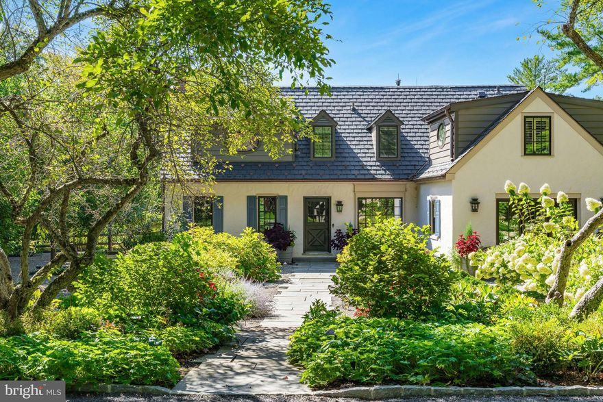 The winding country roads of Solebury Township are an idyllic backdrop for this elegant gated estate. Surrounded by twelve acres of rolling meadows and verdant woodlands, this bucolic property offers a serene and secluded retreat like no other. 

Holmquist Farm epitomizes a harmonious coexistence between nature and the comforts of home. Every aspect of the property has been renewed or improved in the last three years, including stunning new floors and unique light fixtures throughout the main house, a detached garage with luxe guest house, extensive landscaping, infinity pool, and even a pickleball court. 

Entry begins with a classic formal living room with deep silled windows, walls of built-ins, and a wood-burning fireplace. The large family room boasts a 2-story vaulted ceiling with reclaimed wood beams and massive chandeliers, along with a floor-to-ceiling stone fireplace flanked by tall windows. The 2022 gourmet kitchen is a chef’s dream, with marble backsplash, soft close cabinets, burnished bronze fixtures, and a large island. The dining room is elegant with hand painted orchids adorning the walls and French doors leading out to a bluestone patio surrounded by stately rows of flowering trees.

The luxurious first floor primary suite is a private oasis, with a high ceiling, lavish spa bath, and sliding glass doors to an ivy-draped patio. Upstairs, another full bedroom suite includes a built-in window seat, two Juliet balconies, and private bath, while two additional bedrooms share an updated hall bath. The finished lower level delights with a fully equipped wet bar, flex room suitable for a home office or extra bedroom, and wine room. A home theater, full bath, and stairs to the outside make this a wonderful space to entertain family and friends.

The grounds are ideal for entertaining or quiet days at home. Flowering trees and specimen plantings surround the home, while lush grass extends to a heated in-ground saltwater infinity pool with laminar jets. Surrounded by bluestone patios, this scenic overlook offers long-distance views overlooking open farmland and the hills and valleys of Solebury Township.

Across the driveway a newly built detached garage offers four bays with space for five vehicles. The upstairs guest apartment is an elegant residence on its own. An open-plan living area includes a full kitchen, positioned to take advantage of the oversized picture window looking out over the gardens. The custom marble backsplash is a work of art featuring flowering branches with dimensional marble petals. Two sunny bedrooms and a full bath are nearby, as well as a state of the art exercise room featuring a patented hardwood floor with subfloor spring mechanism and Nanawall that opens to the beautiful environs.

The property was once owned by Miss Karline Holmquist, founder of The Holmquist School for Girls, which merged with a local boys school to become the co-educational Solebury School, whose campus is located just up the road. Peace and quiet, a secluded haven within 90 minutes from three major metropolitan cities with access to international airports, world-class arts, cultural amenities, entertainment, shopping, and fine cuisine can all be yours at Holmquist Farm!
