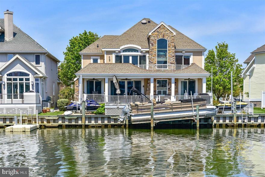 Magnificent luxurious custom 4BR/4.5BA direct waterfront home in Heron Harbour Isle has just been listed!   This home is stunning with spectacular canal and Bay views and desirable southern exposure.  There is a boat slip with  lift and two jet ski lifts for all your water toys.  From the minute you walk in the front door you will fall in love with this home. There is a large family room with a gas fireplace for year around enjoyment.  The dining area flows off the family room and kitchen.  The kitchen has a large breakfast bar, Corian countertops and plenty of cabinet space.  The first floor also has a guest suite with full bath and your guest will be delighted with the view of the Ocean City skyline lit up at night.  There is also a laundry room and pantry on the first level that lead to the oversized garage.  On the second floor there is a spacious master suite overlooking the water with a large walk in closet and full bath with jacuzzi tub and shower.  The master has a glass slider leading to the deck to watch sunsets.  There are two more bedrooms on this level and each has its own private bath and oversize walk-in closet.  The outdoor space is incredible and the perfect space to entertain family and friends.  Relax in one of the lounge chairs and soak in the sun or sit under the covered deck and read a book in the shade. Enjoy a crab feast or barbeque on the large deck overlooking the water. There's kayaking and paddle boarding for some quiet time on the Bay, and jet skiing and motor boating when high powered watersports are calling your name.  This home is in the amenity rich community of Heron Harbour. The community amenities include an indoor heated pool, outdoor family pool, Olympic size lap pool, kiddie pool, fitness center, library, social room and two lighted clay tennis courts. This is more than a luxurious home, it's a wonderful lifestyle.