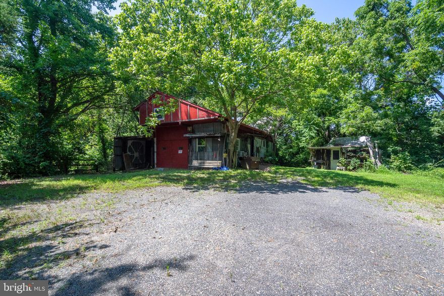 This unique property offers a total of 9.08 acres. Value is in the land.  Whether you're dreaming of a private retreat, hobby farm, or full restoration project, this property is full of potential. The land features a pasture, a pond, a main home built in 1949, a 3-bedroom, 2-bath apartment above the carport, one double wide trailer, a large barn/workshop, and several smaller outbuildings. 5292 Moreland Rd is 8.75 acre, zoned RA, Tax ID 020100090035380. Cottonwood Dr is .33 acre, zoned OS, Tax ID 020149590043179. There are two septic systems on the property, one serving the original 1949 house and one serving the trailer. (Trailer has a permit.) Seller has no septic reports. Anne Arundel County has no records for the current septic systems, however the county has passing percs on file (see provided documents). Property has one well, AACo well info is available. Original 1949 house could have mold and has visibly sloping floors on main level (basement below). Sold AS IS. Property doesn't appear to be eligible for any financing. Proof of funds required prior to showings. PROPERTY IS OCCUPIED, SHOWINGS BY APPOINTMENT ONLY.