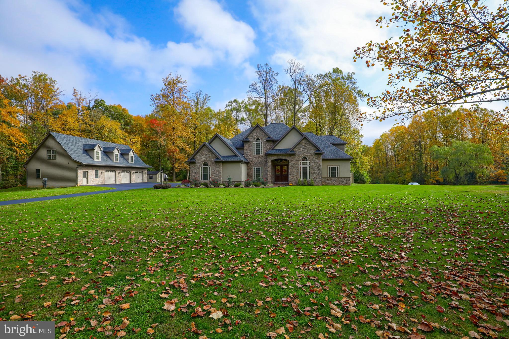Stately and Proud spacious home with integral 3 car garage and an additional large detached 3 car garage building with 2 bedroom in-law quarters on almost 4 acres of land! This home boasts numerous luxury amenities including cathedral ceilings, large office/study room, spacious kitchen with breakfast area, formal dining room and well appointed first floor master suite. Ornamental stone, marble and tile floors are heated throughout the house. Two bedrooms have en-suite bathrooms with gorgeous decorative tile showers, the remaining have a Jack-And-Jill set up. Decorative tiled bathrooms, showers and whirlpool tub will appeal to the most refined of tastes! Finished basement is the entertainment and recreation heaven with bar and full kitchen, large and tall game recreation center with wood beam accents, home theater, personal spa, sauna and a steam room! Separately metered detached garage has three 36' deep garage bays, fully finished. In-law quarters apartment in this building also features luxurious and stately tall ceiling modern kitchen, two bedrooms, extra large walk-in closet, beautiful tiled bathroom & shower and a private deck. Home was built with energy efficiency in focus with R30 Walls and Geothermal heating and cooling. There are two wells on the property. One is currently used for water supply, another for geothermal heating. Both are designed to be used for water supply, if desired in the future. Check the 360 degree virtual tours: House: https://my.matterport.com/show/?m=d9NgPQVS5B2&brand=0 Detached Garage and 2-bedroom in-law suite: https://my.matterport.com/show/?m=a2x7tAZKyC9&brand=0 Watch the video tour here: https://youtu.be/6V11xZf78SM