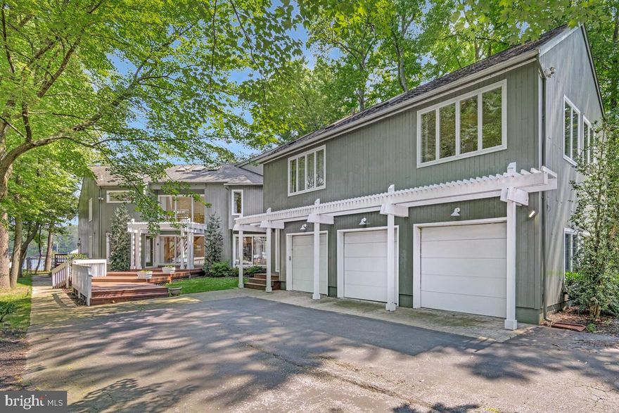 Magothy River Waterfront Retreat blending luxury, space, beauty and comfort in one exceptional property! A rare Contemporary find in Severna Park! This 6 bedroom, 3 1/2 bath home offers tranquil views of the Magothy River from most rooms. Enter into the open concept design and take in the view. Expansive room sizes make this the ideal home for entertaining or everyday living. A gas fireplace is featured in the family room which steps out to the large water side deck. The 2-story breakfast room with water view is just off the gourmet kitchen with stainless appliances, granite counter tops and generous cabinetry.  A front and rear staircase leads to the expansive 2nd story. The luxurious primary suite features a lovely water view, vaulted ceiling, skylights, 2 walk-in closets, gas fireplace, and spacious bath featuring a walk-in shower and soaking tub. 5 additional oversized bedrooms most with vaulted ceilings and skylights. The upstairs family room with gas fireplace is perfect for get togethers. The separate Carriage House is ideal for multi-generational living, a studio or in home office. The pier features 4 boat slips and 2 lifts...perfect for the boat enthusiast! Every detail is designed to take full advantage of the breathtaking waterfront setting. Whether you're relaxing on the deck or enjoying special time with family and friends, this home is a rare find on the Magothy!