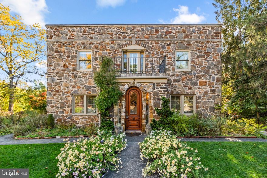 Elegant stone residence brimming with character, offering 3 bedrooms, 2 full bathrooms, 2 half bathrooms, and 3,381 finished square feet in Historic Towson Estates. This enchanting home showcases storybook curb appeal, with lush garden-lined pathways, a Juliet entryway, and timeless architectural details that hint at its rich heritage. 

Step inside to find hardwood floors flowing through the traditional main level. The foyer opens through French doors to a spacious living room featuring a stone-accented wood-burning fireplace and built-in bookcases—a perfect blend of warmth and sophistication. Opposite the foyer, the formal dining room impresses with vintage wallpaper and an elegant chandelier that complements the home’s historic charm. The large eat-in kitchen exudes character with granite countertops, a decorative backsplash, and rich cherry cabinetry offering ample storage. From here, step into the sunroom, a captivating retreat enclosed in panoramic glass windows, creating a light-filled sanctuary that brings the outdoors in.

Upstairs, hardwood floors continue throughout three bedrooms, including an expansive primary suite with double closets, a private sitting area, a loft with balcony access, and a spa-like en suite bathroom. A second full bathroom serves the additional bedrooms with equal charm. One of the bedrooms has a private balcony. The lower level is a treasure of its own, featuring a recreation room with hardwood floors, stone walls, a second stone fireplace, and exposed beams that showcase the home’s craftsmanship. Two bonus areas with built-ins, a half bathroom, laundry room, and a former darkroom provide character-rich versatility. Outdoor living is equally magical, with meandering stone walkways, vibrant gardens, and a stone fish pond, all set against a wooded backdrop for added privacy. A two-car garage and private driveway provide convenience and ample parking. 

Nestled within Towson Estates, a neighborhood celebrated for its old-world charm and early 20th-century architecture, this residence is part of a community where stone walls, gardens, and fountains create a picturesque, timeless atmosphere. The neighborhood association is dedicated to preserving its historic integrity, ensuring each home retains its distinctive character. Tucked away on quiet, no-through streets, yet just minutes from shopping, dining, major commuter routes, and amenities, this home offers the perfect harmony of history, privacy, and convenience. *Property is being sold As-Is, Fireplaces are decorative only, not usable. Furnace/Boiler and Water Heater recently replaced (gas; chimney liner installed)