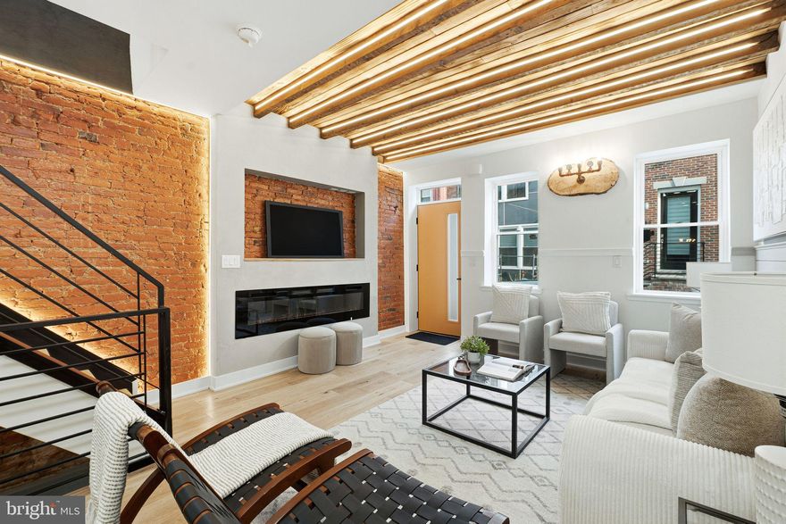 Welcome to 1410 S Bouvier St, this stunning, brand-new, fully renovated 3-bedroom, 3-bathroom home with a 10-YEAR TAX ABATEMENT . in the heart of Point Breeze!  From the moment you walk in, you are greeted by a modern lime-wash painted fireplace, beautiful engineered hardwood floors, and custom lights and fixtures throughout, offering a perfect blend of character, style, and modern upgrades. The spacious living room features exposed beams with a wooden ceiling accent, a shiplap feature wall, a fireplace accent wall, and lights highlighting the original brick details. The open-concept dining area flows seamlessly into a fully custom-built chef’s kitchen, complete with ample cabinetry, reclaimed-wood open shelves, a built-in wine rack, and stainless steel appliances. Upstairs, the second floor offers a full hall bath with a beautiful custom shower, and a convenient dry bar. The rear bedroom is perfectly sized with a custom closet and modern finishes. The gorgeous master bedroom boasts a large, lit accent wall, a built-in custom closet, a reclaimed-wood vanity station, and wooden barn doors leading to the extravagant master bathroom, featuring a reclaimed-wood double vanity, a custom accent wall and a tub surrounded by perfect tile work. In the finished basement, you will find a humongous full bedroom with a modern, custom-built closet, perfect for guests, and a chic full bathroom. The laundry space and mechanical closet are also in the basement. Located next to a bunch of businesses and restaurants in prime Point Breeze, this home combines modern elegance with neighborhood charm. Reach out to schedule your showing today!