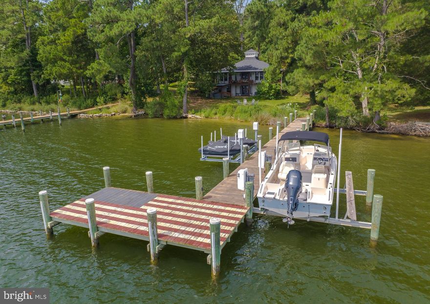 Waterfront Paradise with Tons of Upgrades!!
Discover your dream home in this fully renovated waterfront haven, perfectly designed for both relaxation and entertainment. This property boasts deep water access, ideal for sailboats, complete with a private dock featuring two jet ski lifts and a boat lift.
Inside you will find  a fully renovated kitchen with top-of-the-line Bosch and Samsung appliances, Grohe faucet, honed Carrara marble countertops, and Kitchenaid cabinets,  Fully renovated baths with custom sinks and tile floors plus large walk in shower in lower level bathroom. 
Luxurious Flooring: Amish poplar flooring upstairs and luxury vinyl plank downstairs.
Custom Finishes: Solid oak interior doors, cedar paneling on upstairs walls and ceilings, cedar closets and organizers, and cedar beams.
Tankless gas water heater, water filtration and softener system.]s
Energy efficiency has been upgraded with new windows and exterior doors, and tankless gas water heater
Outdoors you'll find an expansive covered wraparound porch with 1400 square feet custom finished with  tigerwood deck, perfect for gatherings and outdoor dining.
relax in the  6-person spa under a covered metal roof or nap on the  twin-size custom porch swing for serene moments by the water.
New metal and shingle roof, new cedar-style vinyl siding, 3-car carport, and a spacious 24x12 shed.
 The property is adorned with many mature trees, including figs, cherry, oaks, pine, and cedar.
This home is a rare gem that combines custom features, functionality, and natural beauty, offering an unique waterfront living experience. Don't miss the chance to own this exceptional property!