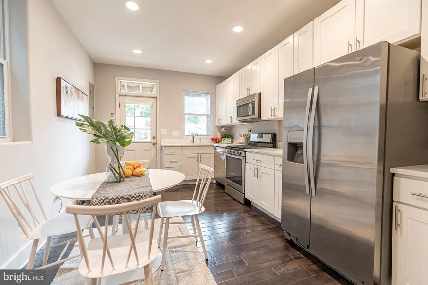 Welcome to this gorgeous, semi-detached home with over five years of the CHAP tax credit remaining!  Prime, park-front location that's in such a walkable spot, close to all of Hampden's bars, restaurants and shops on The Avenue! Cutting edge style has been combined with high-end finishes in spaces that naturally flow for the modern buyer.  The living room is open to the custom kitchen with stainless steel appliances, quartz countertops, and gas stove.  A half bathroom and coat closet are between the living room and kitchen.  The primary bedroom has a private view of the park and beautiful en suite bathroom.  The secondary bedroom has access to the second floor balcony.  A second full bathroom and laundry complete the second floor.  Enjoy relaxing or working from home in the finished basement.  Additional features include glistening hardwood floors throughout, two car parking, and fenced in backyard with deck.  A dream for entertainers, gardeners, and pet lovers!  Schedule a tour now to see the home you've been searching for!