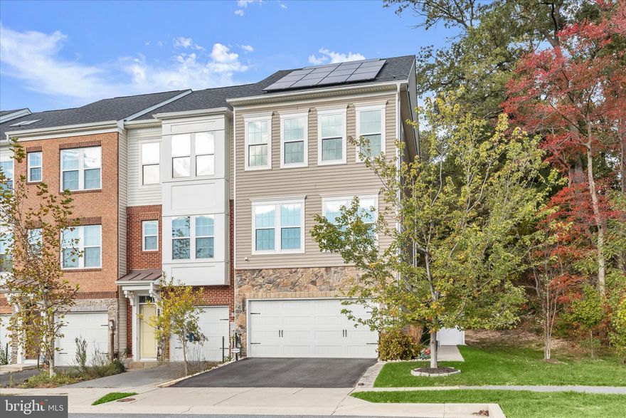 Perfectly positioned as an end-unit in the amenity-rich Shipley Homestead community, this garage townhome offers a peaceful view of trees and a thoughtful blend of space, style, and function. Built in 2018 by Pulte and meticulously maintained by the original owner, the home welcomes you with an open-concept main level where hardwood flooring and high ceilings create an airy, inviting atmosphere.
The kitchen serves as the heart of the home, featuring beautiful cabinetry, granite countertops, an expansive island with breakfast bar seating, stainless steel appliances including a gas range, and a generous pantry. From here, step directly onto the deck, complete with a gas line ready for grilling, making outdoor entertaining effortless. The kitchen flows seamlessly into the dining area and then into the bright living room, while a conveniently placed powder room completes the main level.
Upstairs, the bedroom level begins with a spacious primary suite designed for comfort, offering two walk-in closets with custom built-ins and a well-appointed primary bath with a double-sink vanity and a large tiled shower enclosed by frameless glass. Two additional bedrooms share a full hall bath, and a bedroom-level laundry room adds everyday convenience.
The entry level provides flexible living space with a family room that easily adapts as an exercise area, hobby room, or home office. This level opens to a private back patio with privacy fencing and a thoughtfully designed backyard featuring rock accents and a stone path. Under-decking helps protect the patio below from excess rain, enhancing its comfort and usability and extending the enjoyment of the outdoor space.
Additional highlights include a two-car garage with finished walls and epoxy flooring, a water softener, irrigation system for the front and side yards, gutter guards, and a camera system. As part of Shipley Homestead residents enjoy a resort-style clubhouse with fitness center, three outdoor pools, playgrounds, a soccer field, dog park, community garden, and inviting gathering spaces, all within easy reach of major commuter routes and nearby destinations.