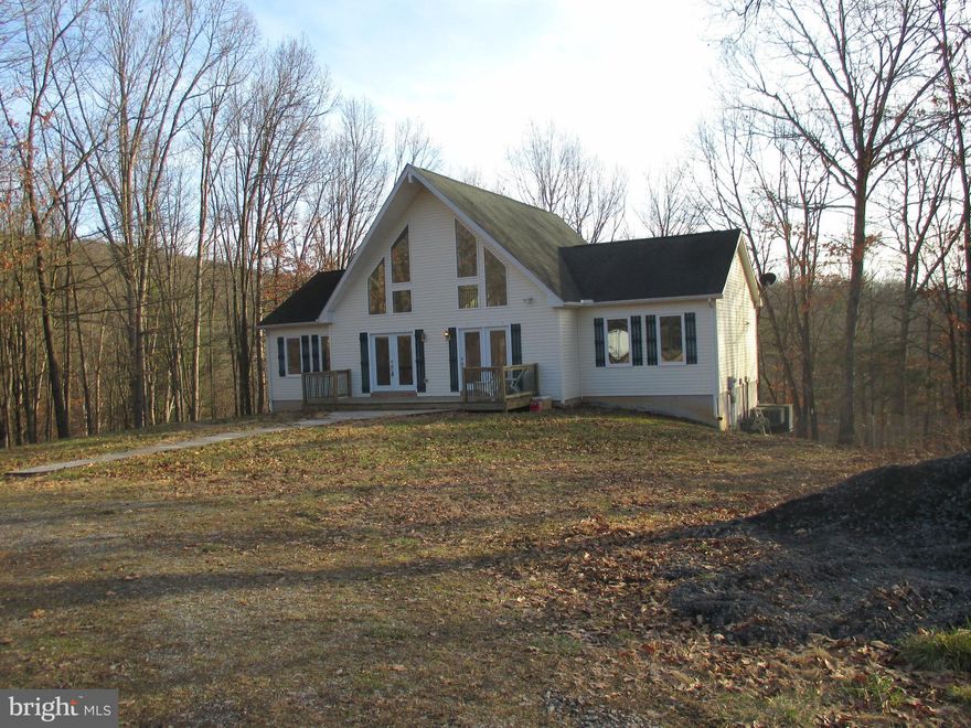 READY TO LIVE IN THE SECLUSION AND PRIVACY OF YOUR VERY OWN COUNTRY ESTATE? THIS REMARKABLE HOME HAS EVERYTHING YOU COULD WANT. PRIVATE WOODED SETTING ON 5.8 ACRES AND A BEAUTIFUL MOVE-IN READY HOME. HUGE OPEN LIVING ROOM WITH VAULTED CEILINGS AND HARDWOOD FLOORS, LARGE EAT-IN KITCHEN WITH A BREAKFAST BAR, AND AMPLE TABLE SPACE TO ACCOMODATE ENTERTAINING. OWNERS SUITE FEATURES A FULL BATH WITH A NICE SIZED WALK-IN CLOSET. 2 OTHER BEDROOMS AND A FULL BATH ON THE MAIN LEVEL WITH 1 BR HAVING SLIDING GLASS DOORS TO THE OVERSIZED DECK. LARGE LOFT AREA WOULD BE IDEAL FOR A HOME OFFICE OR FAMILY ROOM. BASEMENT FEATURES A 4TH BEDROOM WITH LAMINATE FLOORING AND A WALK-IN CLOSET. BASEMENT BATH HAS IT ALL WITH A JETTED GARDEN TUB/SHOWER, AND SINK WITH VANITY. THE REST OF THE UNFINISHED BASEMENT HAS HIGH CEILINGS THAT COULD BE FINISHED OFF INTO GREATER LIVING SPACE, WITH WALK-OUT GROUND LEVEL DOORS. BETTER HURRY ON THIS ONE BECAUSE THIS GEM IN THE MOUNTAINS OF WEST VIRGINIA WILL NOT LAST LONG.