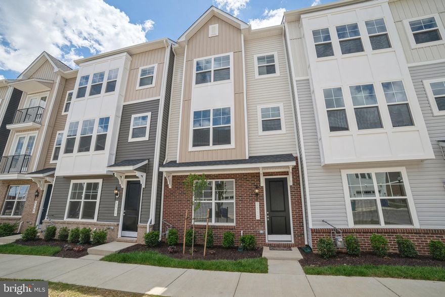 Experience the comfort and convenience of this Kempton I floorplan townhome featuring 3 bedrooms, 2 full baths, 2 half baths, and a 2-car garage. The gourmet kitchen includes a cooktop, double oven, stainless steel appliances, quartz countertops, upgraded cabinetry, a contrasting island with pendant lighting, and a spacious walk-in pantry.

A finished rec room enhances the main level, while the first upper level offers an open great room and dining area with luxury vinyl plank flooring and oak stairs. The second upper level hosts all three bedrooms, including a primary suite with an upgraded bath featuring a double-vanity with quartz countertops, walk-in shower, and upgraded ceramic tile. Laundry is conveniently located on the bedroom level.

Located just one mile from Route 15 and minutes from shops, restaurants, grocery stores, entertainment, and Historic Downtown Frederick.