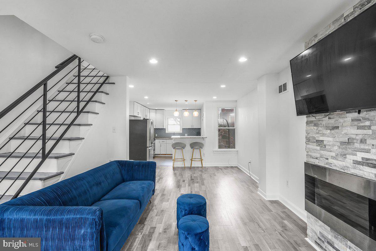 Step inside this turnkey townhome, where every detail has been thoughtfully refreshed to blend modern style with everyday comfort. Enjoy your morning coffee or evening chats on the charming front porch, complete with durable composite decking and space for your favorite rocking chairs. Sunlight pours across sleek grey hardwood floors throughout the open floorplan. The seamless flow from living to dining areas creates a welcoming backdrop for gatherings large and small. Prepare meals in a gourmet kitchen featuring a granite island and countertops, and custom cabinetry. Bar seating gives the option of casual dining. A private deck creates a sense of an oasis. Upstairs boasts three generously sized bedrooms. Main suite impresses with a spacious walk-in closet designed to accommodate an extensive wardrobe. The fully finished basement expands your living square footage, complete with recessed lighting and a convenient powder room. Ideal for a home office, media room, or fitness studio.