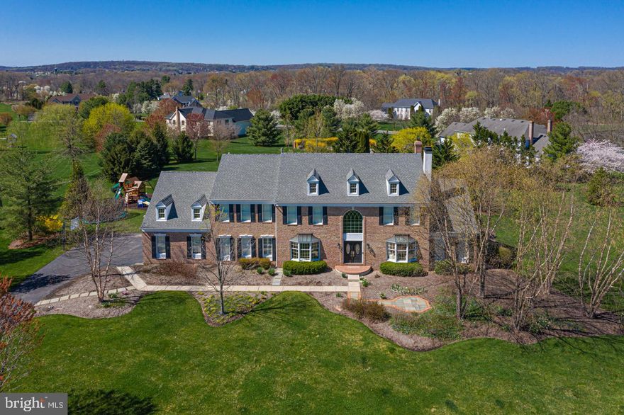 Welcome to this beautiful, thoughtfully appointed and elegantly updated brick front colonial on 2 acres. Offering a private setting with gorgeous long distance views outside and wonderful millwork and hardwood floors inside, this home is impressive and move-in ready! Just through the front door, the grand 2 story foyer with curved staircase opens to the rest of the home in all directions. Detailed, custom dentil molding flanks the entrances to the spacious living room which is bright and distinguished by a gas fireplace with a beautiful marble surround and an elegant dining room featuring a large bay window overlooking the landscaped front yard. The living room opens to the sun-drenched conservatory which is currently being used as a playroom, spacious and ideal for a multitude of uses, it can be closed off for privacy. The gathering room is gorgeous and inviting with a wall of windows framing the lovely manicured yard and pool. A room the whole family will enjoy, it features a gas fireplace with a marble surround, neatly tucked between beautiful built-in cabinetry. The gourmet kitchen boasts plenty of raised panel cabinetry, granite counters, a center island with additional seating and a large walk in pantry. Ideal for entertaining, a spacious butlers pantry is an added bonus tucked off the kitchen and makes for a wonderful serving area or coffee bar! The bright and sunny breakfast area has a sliding door that opens onto the deck just steps away from the newly renovated heated saltwater pool with a custom rock waterfall. Ideal for backyard entertaining, the outside features multiple seating areas. Directly off of the kitchen is a bright den boasting beautiful custom built-ins with a leathered quartzite countertop and plantation shutters. Completing the first floor is a half bath, convenient drop-zone area with bench and overhead storage cubbies and laundry/mud room. Upstairs by either the main or rear staircase you are greeted by a spacious hallway overlooking the foyer on one side and the kitchen on the other. Enter through double doors to the main bedroom which is spacious and highlights a tray ceiling, 2 large walk-in closets, and an oversized sitting room currently being utilized as a home office. The main bath is neutral and offers plenty of cabinetry, dual vanities, a soaking tub and an oversized spa-like shower. Two additional bedrooms share a spacious Jack and Jill bath and the 4th bedroom is en-suite with a huge walk-in closet. The newly updated finished basement provides additional living space and has multiple entertainment areas, recessed lighting and wonderful storage. Additional amenities include new carpet, fresh paint, recessed lighting throughout, great natural light and a 3 car garage. An amazing home in Council Rock schools, convenient to so many options for shopping and dining in Newtown, Doylestown, Buckingham and New Hope.