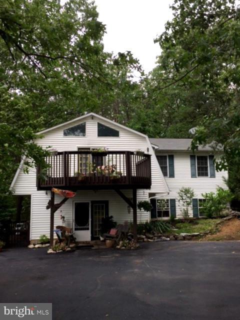 UNIQUE, BEAUTIFUL, STYLISH! Come see this astonishing house offering over 2000 square feet of living space. Nested among woods offering an indulging life style, this house offers lovely living spaces inside and out. All newer appliances, efficient and heartwarming pellet stove, remodeled baths, updated kitchen, a wonderful balcony to watch the stars from the privacy of a beautiful master bedroom