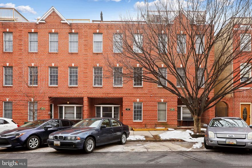 Welcome to your gorgeous porch front 3-story, 18-foot brick townhome with a 2-car garage! This beautifully updated home features a new bedroom/office with a full bath on the 1st floor, hardwood floors throughout, and an open floor plan created by removing walls for a spacious and inviting atmosphere. The large family room, complete with a cozy gas fireplace, is perfect for gatherings, complemented by an ample dining area for family meals. The kitchen has been recently refreshed with new appliances, countertops, and a large pantry, making it a delightful space for cooking. Step out onto the grill deck right off the kitchen, or relax on the stunning roof deck, which offers breathtaking city and water views. The renovated primary suite includes a luxurious ensuite bath and a generous walk-in closet. Located in a prime area, you are less than a 10-minute walk from lively Canton Square and the historic Fells Point, home to the newly remodeled Broadway Market. Enjoy easy access to Patterson Park and the Inner Harbor Promenade, both just 1.5 blocks away. You’ll also find a variety of shopping and dining options at the Shops at Canton Crossing, Harbor East, Little Italy, and downtown Baltimore. This home is conveniently close to Johns Hopkins Medical Center and major businesses in Harbor East, with quick access to I-95, I-83, and I-695 for effortless commuting. Don’t miss the opportunity to make this stunning townhome yours!
