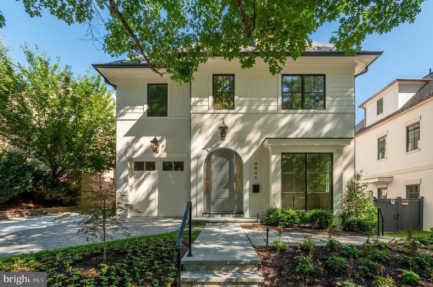 Welcome to 4905 Van Ness Street NW—a refined and newly constructed home that blends timeless architecture with modern luxury in the heart of Spring Valley. Designed by the renowned Danube Group in partnership with KAVA Holdings, GTM Architects, CMX Construction, and acclaimed designer Studio Sophiste, this residence spans approximately 5,352 square feet of exquisitely finished living space across four thoughtfully designed levels, all seamlessly connected by a private elevator. The main level showcases 10-foot ceilings and an open, airy layout ideal for contemporary living - all of which walks out to the rear patio and garden. A spacious living and dining area anchored by a gas fireplace flows into a chef’s kitchen outfitted with high-end appliances, a generous center island, and custom cabinetry. A private study, stylish powder room, mudroom, and access to an attached garage complete this level. The second floor features three well-proportioned bedroom suites, including a tranquil primary retreat with dual walk-in closets and a spa-inspired bathroom. A convenient laundry room and abundant closet space enhance everyday functionality. The third level offers a sunlit family room with vaulted ceilings and charming built-in window seating—perfect for relaxation or gathering—as well as a fourth bedroom suite with its own walk-in closet and bath. The lower level is designed for entertainment and flexible living, offering a fifth bedroom and full bath, a large recreation room with wet bar and wine storage, a separate game room, and a dedicated exercise room. Additional highlights include driveway parking, a rear patio for outdoor enjoyment, and proximity to Spring Valley favorites like Millie’s, Compass Coffee, and Crate & Barrel. Located in the Mann ES / Hardy MS / MacArthur HS boundaries.