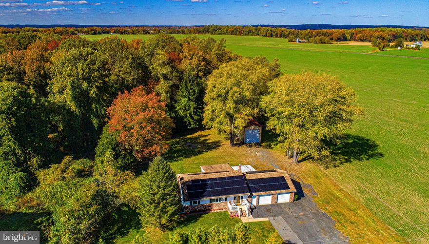 This adorable rancher has so many impressive features! Enjoy over 1,100 sq ft of living space (not including the sunroom), an oversized attached two-car garage, additional detached garage large enough for your boat, RV, or tandem parking, and a long driveway with ample parking- offering endless possibilities for storage or hobbies.

The home offers an inviting layout, spacious rooms, and plenty of natural light! Kitchen has white cabinetry, space for an island or table, and charming wainscoting detail! Open Large living room and dining combo or use the the space as one huge living room! Remodeled main level bath with modern vanity and pretty tile work. Finished lower level has plush carpet, a renovated full bath, and plenty of room for entertaining, movie nights, or everyday recreation.  Enjoy additional flexibility in the inviting sunroom—an ideal spot for gatherings, hobbies, or a party space that opens to the outdoors. A covered brick-floor porch extends your living area and creates the perfect setting for morning coffee, crab feasts, dining, or a lounge area. 

Additional features include hardwood floors, some fresh paint, front porch, arched doorways, vaulted ceilings, ceiling fans, wall-mount AC in sunroom; projector screen in sunroom; mini split in basement; pellet stove in basement and garage; wired for generator.

The property’s exterior is just as impressive— The lot is simply beautiful—backing to woods and adjacent to open farmland for stunning views and privacy.

All this tucked along a country road, yet only minutes from Aberdeen shops, restaurants, APG, and I-95 for easy commuting. Solar panels are leased and help keep utility costs low. Some furniture can convey/is negotiable. 

Don’t miss this exceptional opportunity to own your slice of Harford County charm!