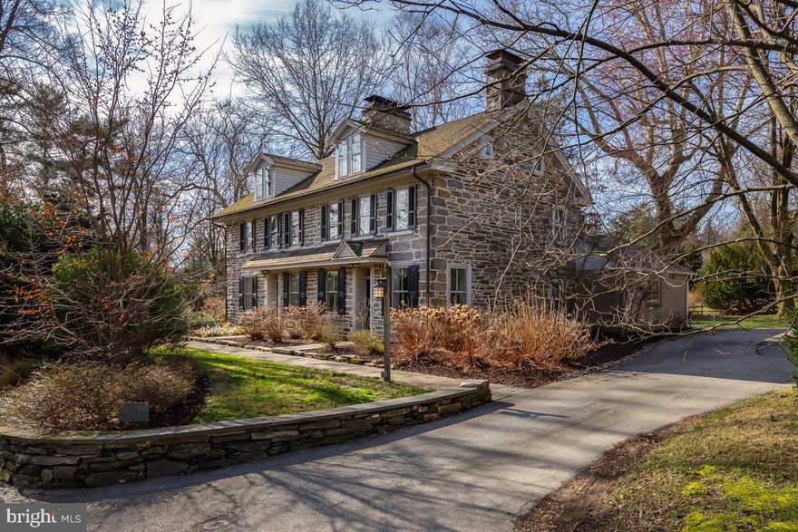 Welcome to The Ogden House, one of Swarthmore’s oldest and most stately homes, filled with modern farmhouse charm. Situated just North of Swarthmore College, this impressive five-bedroom, three-and-a-half-bathroom property is filled with original character and has been meticulously updated to weave in modern amenities for today’s homeowners. The hardscaping perfectly accents the home’s beautiful stone exterior, and the custom copper chimney caps add a perfect touch of historic charm. The front and rear gardens have been consciously designed to accent the home and provide balance to the mature trees that fill the property. 

Inside, original wide plank hardwood flooring greets you and runs throughout the home. The sun-soaked spacious living room feels bright and airy from the large windows with deep sills allowing the light in, yet cozy from the working fireplace with original built-in bookshelves providing additional storage space. An additional seating area can be found through the glass-paned door which provides an intimate setting anchored by a quaint fireplace. The formal dining room features its own fireplace, beautifully exposed beams, a glass-paned door for optional privacy, and access to the home’s rear staircase. 

At the heart of the home sits the kitchen, featuring white painted cabinetry, maple butcher block countertops, and stainless steel appliances. Show off your dishes in the glass-front upper cabinets, and enjoy serene views out the double window over the inset stainless steel sink. A moveable large center island provides additional casual seating, perfect for enjoying quick breakfasts in the morning. This kitchen is complete with a windowed alcove that could be used as a breakfast nook overlooking the quaint English-style garden. Rounding out this level is a convenient powder room, a laundry room with butler’s pantry cabinets, a Meile washer and dryer, and a separate mudroom with direct access to the back yard, all with durable tile flooring. 

The primary suite on the second level hosts an abundance of charm with original hardwood floors and a brick hearth fireplace. The walk-in closet boasts plenty of room for multiple configurations and leads the way to a beautifully updated full bathroom with a stall shower. Two secondary bedrooms on this floor are adorned with crown and chair moldings and are anchored by original fireplaces. Rounding out this floor is an updated full hallway bathroom with a cast iron tub shower and beautiful built-in cabinetry.

The final two bedrooms on the third level are adorned with wainscotting, sloped ceilings, and an exposed stone wall with an abundance of storage space. This space is perfect for secondary bedrooms, a quiet remote office space, or a bonus room. Both bedrooms share the use of a beautifully updated hall bathroom with charming tile flooring, exposed wooden beams, wainscotting, plenty of wall storage, and a tiled stall shower. 

The expansive and private rear yard is just under an acre and contains several beautiful trees and one of the largest Sycamores in Swarthmore. The gardens that surround the home contain perennials and trees that will be a gardener’s dream. In addition, the yard hosts multiple seating areas as well as a hardscape firepit, ideal for entertaining all year long. The property is completed with a long driveway leading to the original carriage house with large barn doors and a Spring House which would make the perfect potting shed for the avid gardener. 

Residents can relish the peaceful ambiance of the suburbs, nestled in the heart of the award-winning Wallingford-Swarthmore School District within walking distance to ample greenery, numerous parks, Scott Arboretum, and beautifully groomed trails at Crum Creek. 530 Cedar Lane is conveniently close to public transportation, major thoroughfares for commuting, Springfield Mall, and a plethora of shops and restaurants along Baltimore Pike.