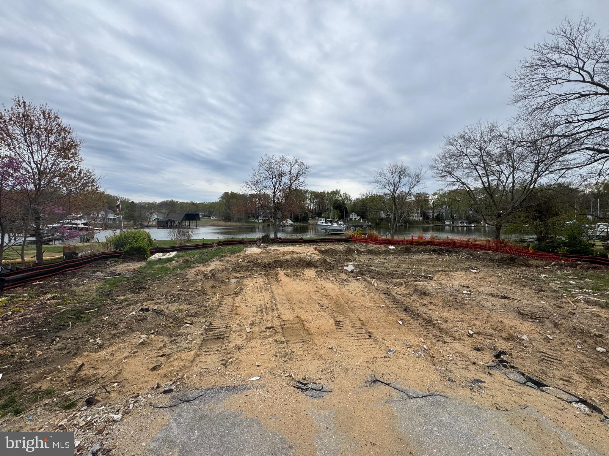 One of a kind flat waterfront lot boasting 157 feet of bulkhead with a private pier and boat lift and deep water, this stunning property offers the epitome of coastal living. On Whitmarsh Creek just off the Rhode River. The sellers bought the property and were issued an approved AA County grading permit to tear down the original house. The house has been torn down and the sellers are about 2 weeks away from having an approved building permit for a 6500 sqft brand new house! The sellers may be moving out of state so they decided it might be time to pass this dream on to a new owner. The price listed is for the land only.